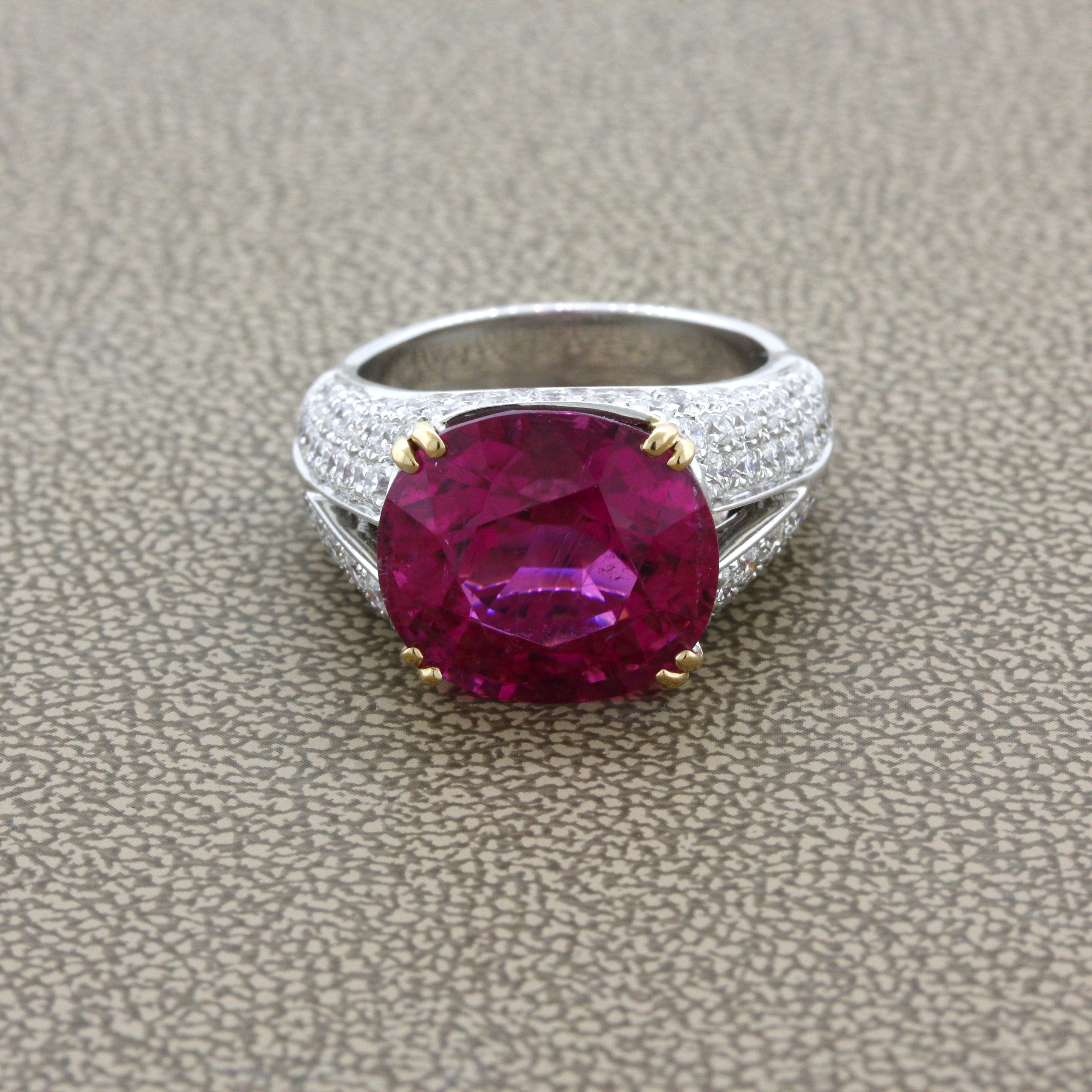 Simply stunning! The ring features an amazing 9.42 carat rubellite tourmaline with the most bright vivid and vibrant color we have seen in a long time! It is a rich pinkish-red color that will make you smile and feel warm inside. It is complemented