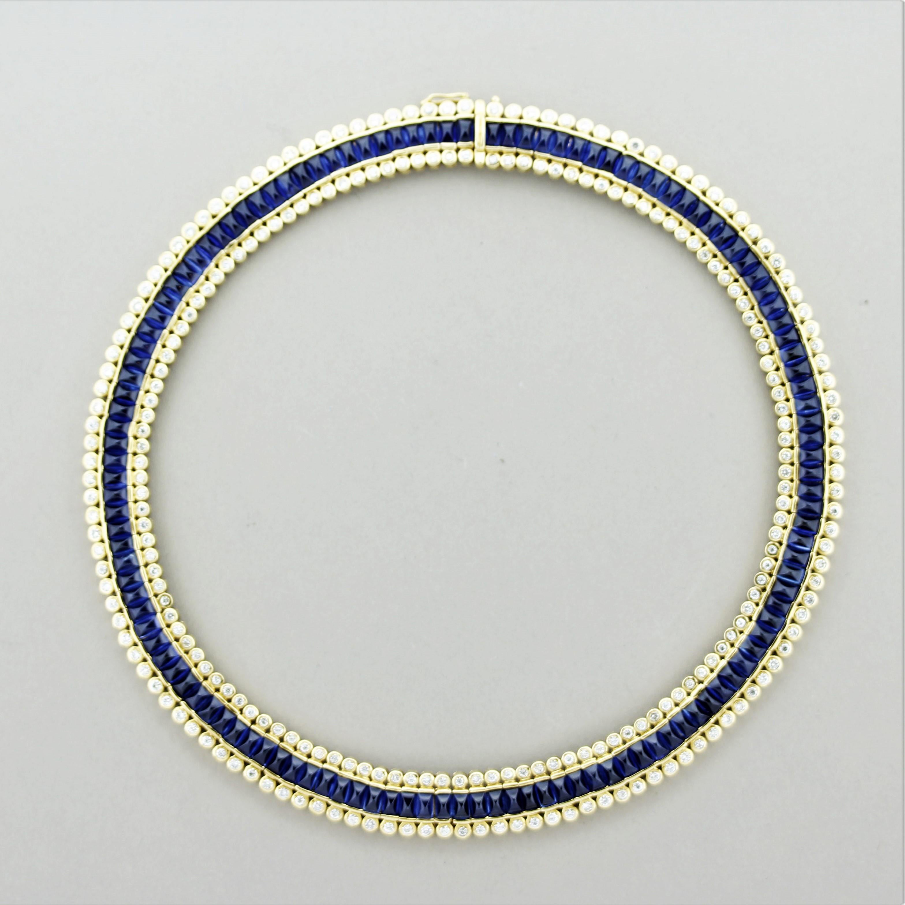 A superb and finely detailed necklace that will bring a smile to your face. It features 47.69 carats of gem sapphire cut as sugerloafs. The sapphires have a rich vivid blue color seen in the finest of sapphires. Accenting the blue gems are 6.61