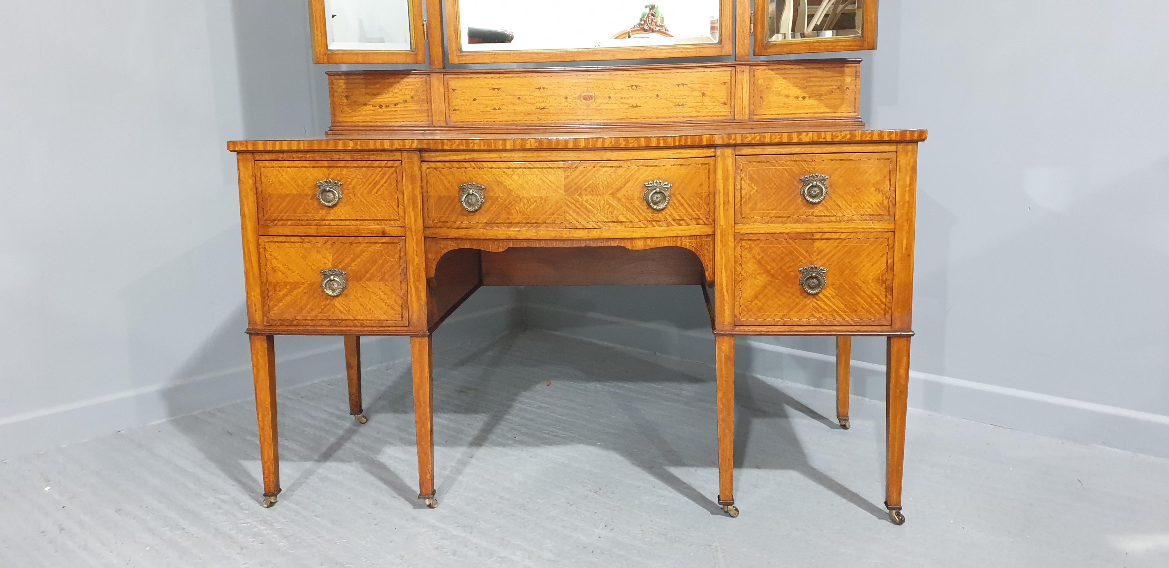 A lovely quality inlaid satinwood tryptic mirrored five drawer dressing table with brass handles, brass castors, in overall very good condition, very slight foxing on central mirror.