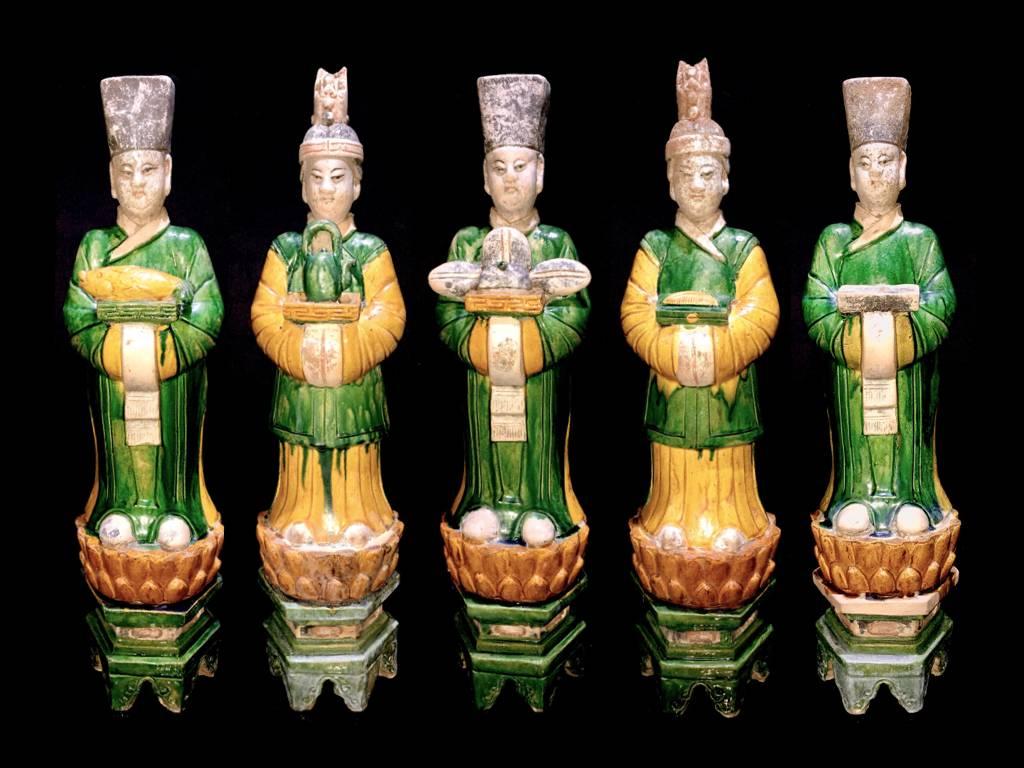 A stunning set of 5 graceful terracotta figurines from the Ming Dynasty '1368-1644' AD.  These elegant attendants are standing on a yellow glazed lotus flower over a high hexagonal green plinth and wear fine robes in matching green and yellow