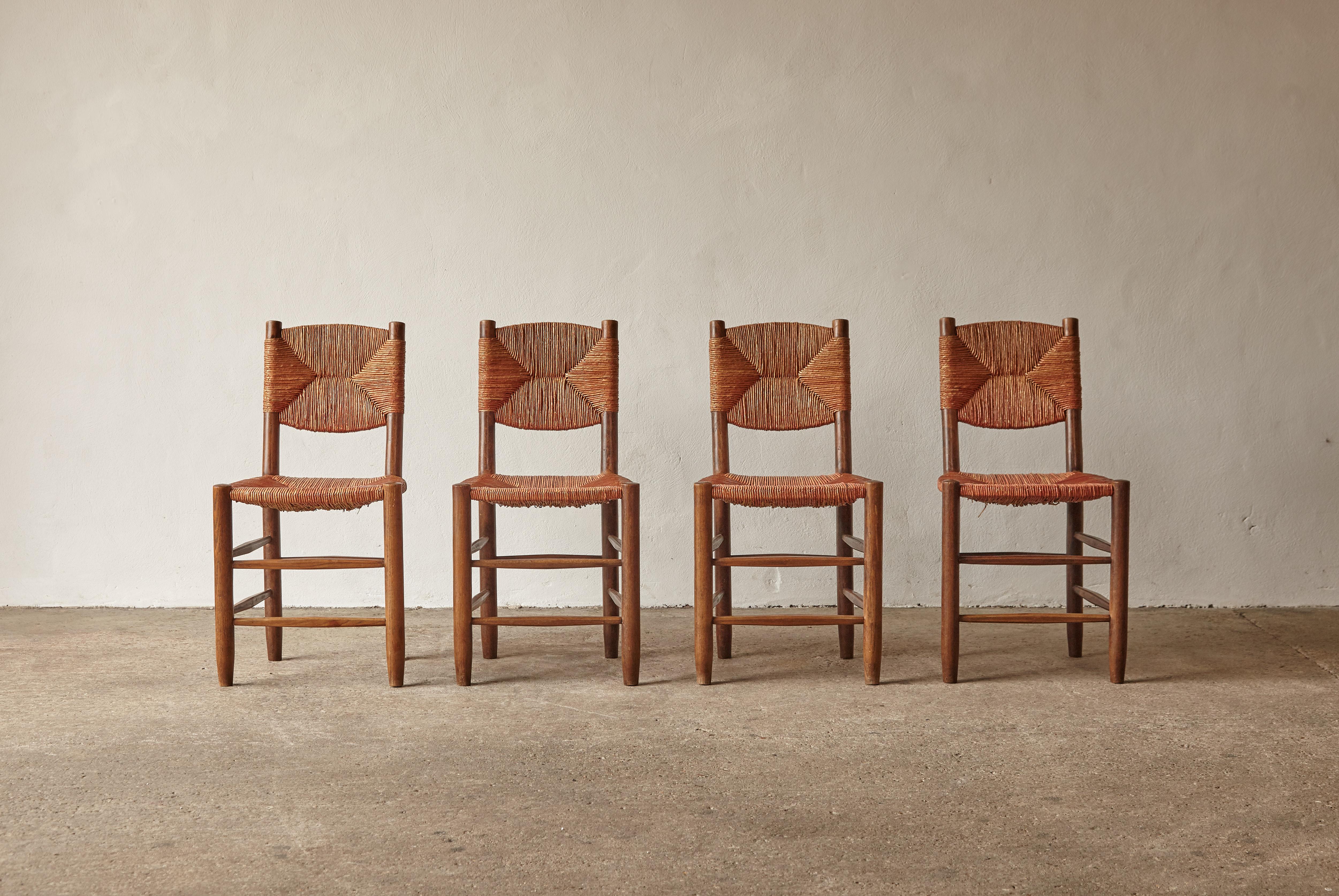 A superb set of Charlotte Perriand Model 19 Bauche chairs, France, 1950s/60s. This early set most likely produced by master cabinetmaker Andre Chetaille at Steph Simon. In original condition and very rarely found with original cordon intact. Good