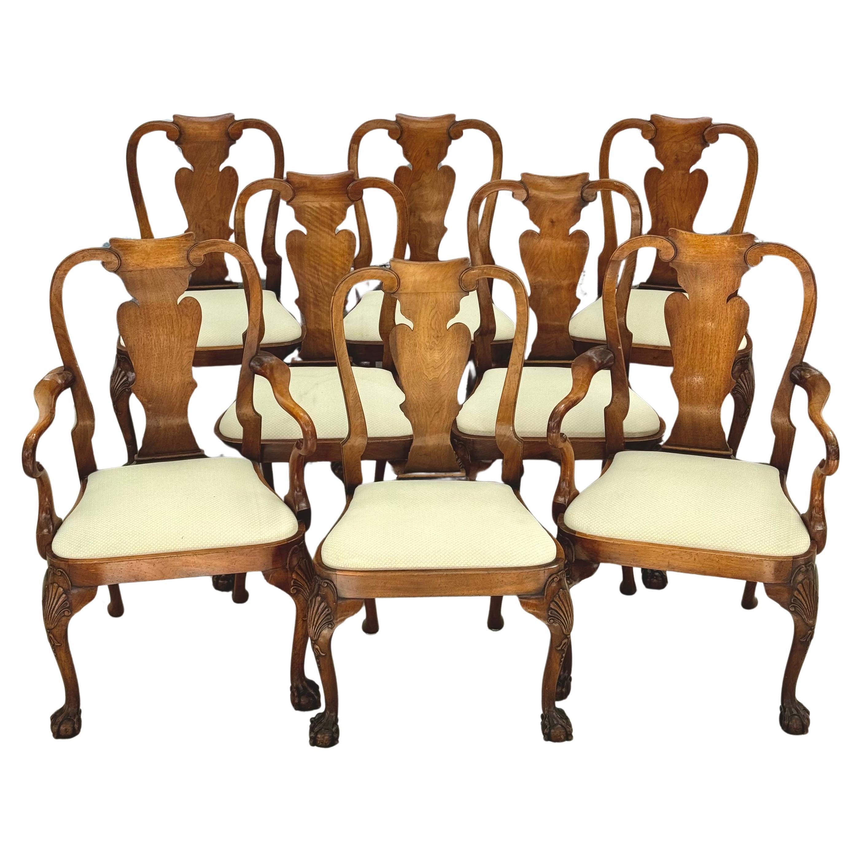 Exquisite set of eight George II Style walnut dining room chairs. There are two arm chairs and four side chairs in set. Each with shaped top rails above a vase-shaped vertical splat, with a drop-in seat above scallop-shell headed cabriole front legs