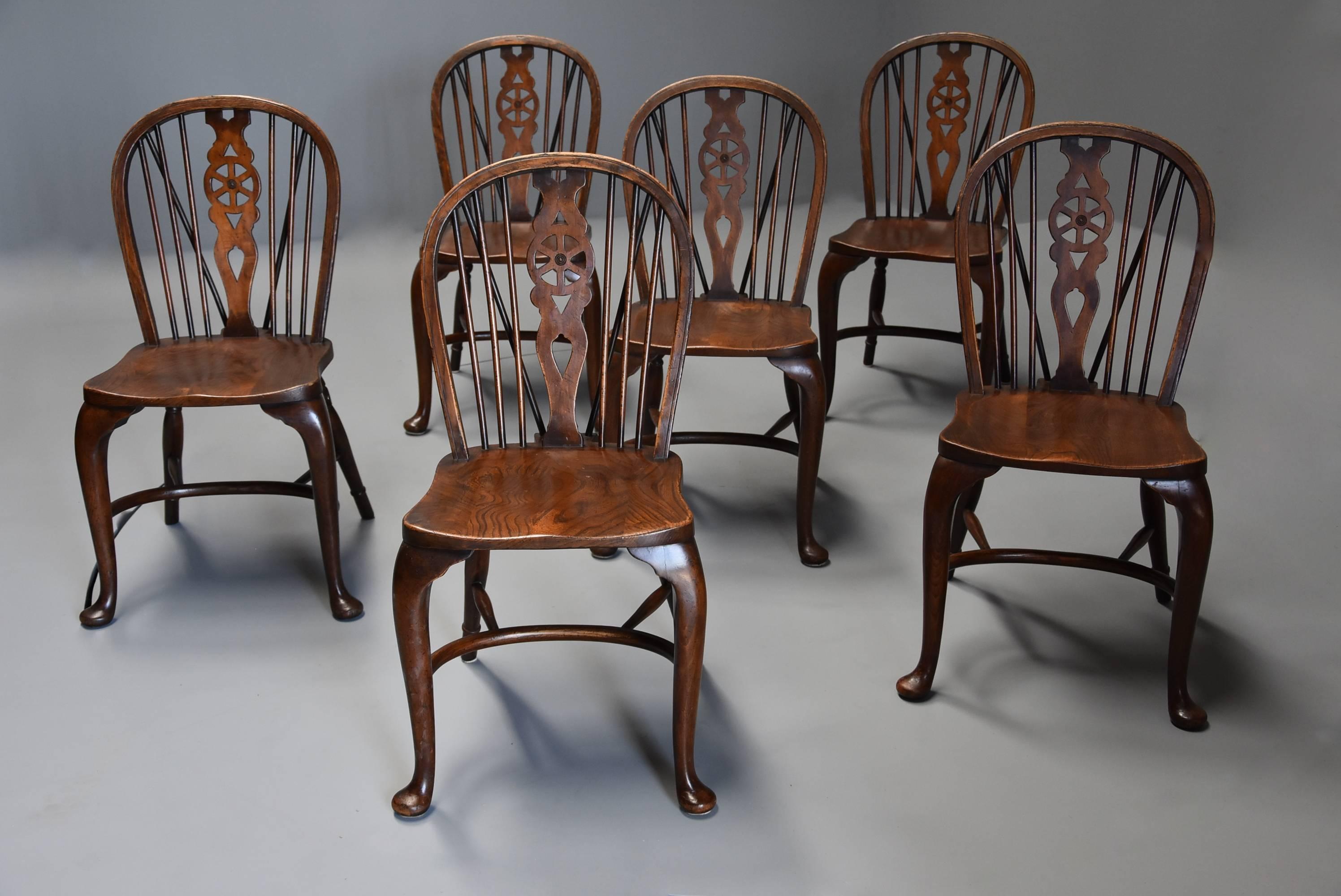 A superb set of six ash and beech wheelback Windsor chairs with cabriole leg with good patina (colour), stamped 'AP'.

This set of chairs consist of a low hoop-back with central pierced splat with wheel design and turned spindles to either side