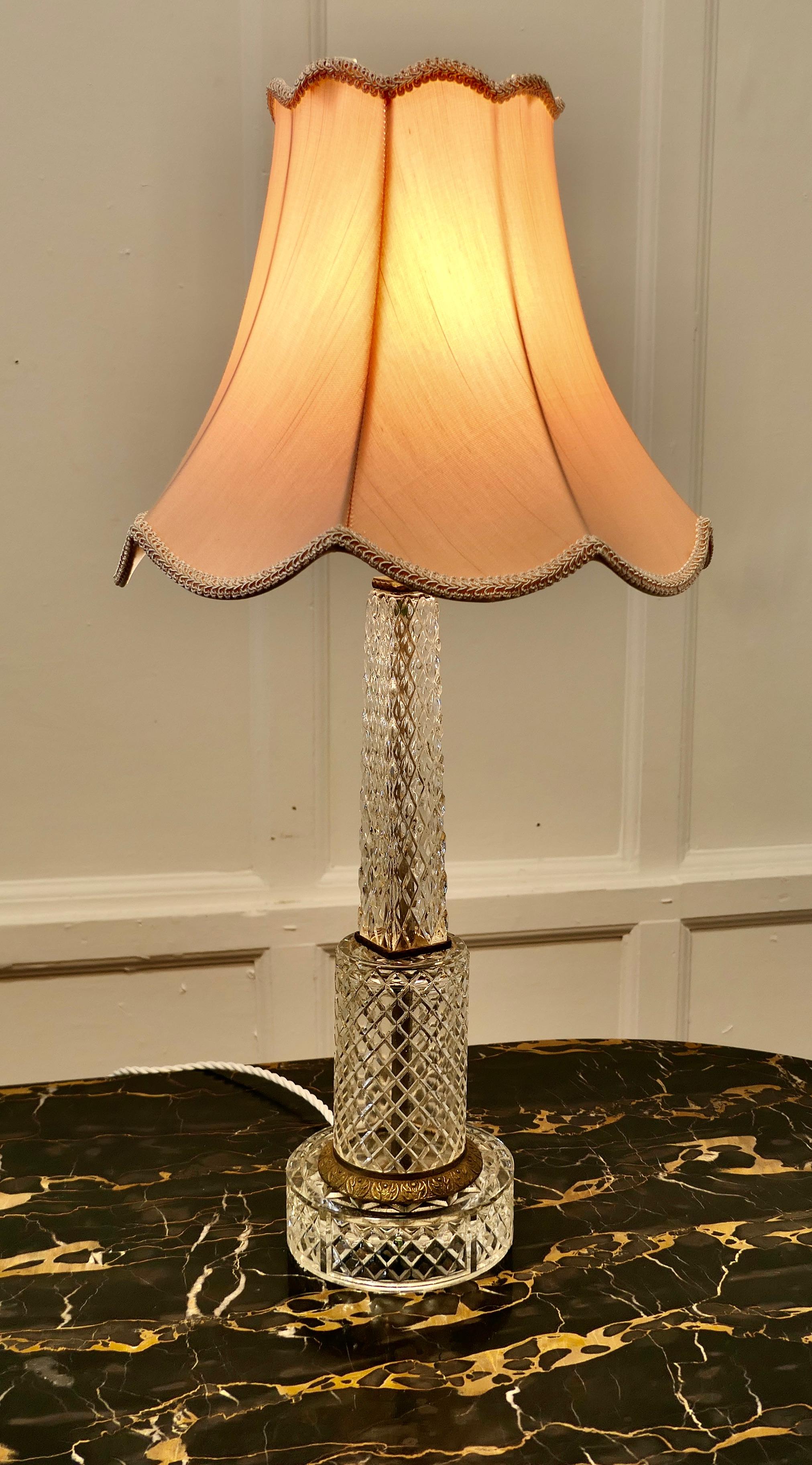 Superb Tall Art Deco Cut Glass Table Lamp 

This is a very pretty piece, the base of the lamp has a Odeon waterfall design, it is made of bright diamond cut glass and set with brass mounts
All the old wiring is new, I have shown it with a salmon
