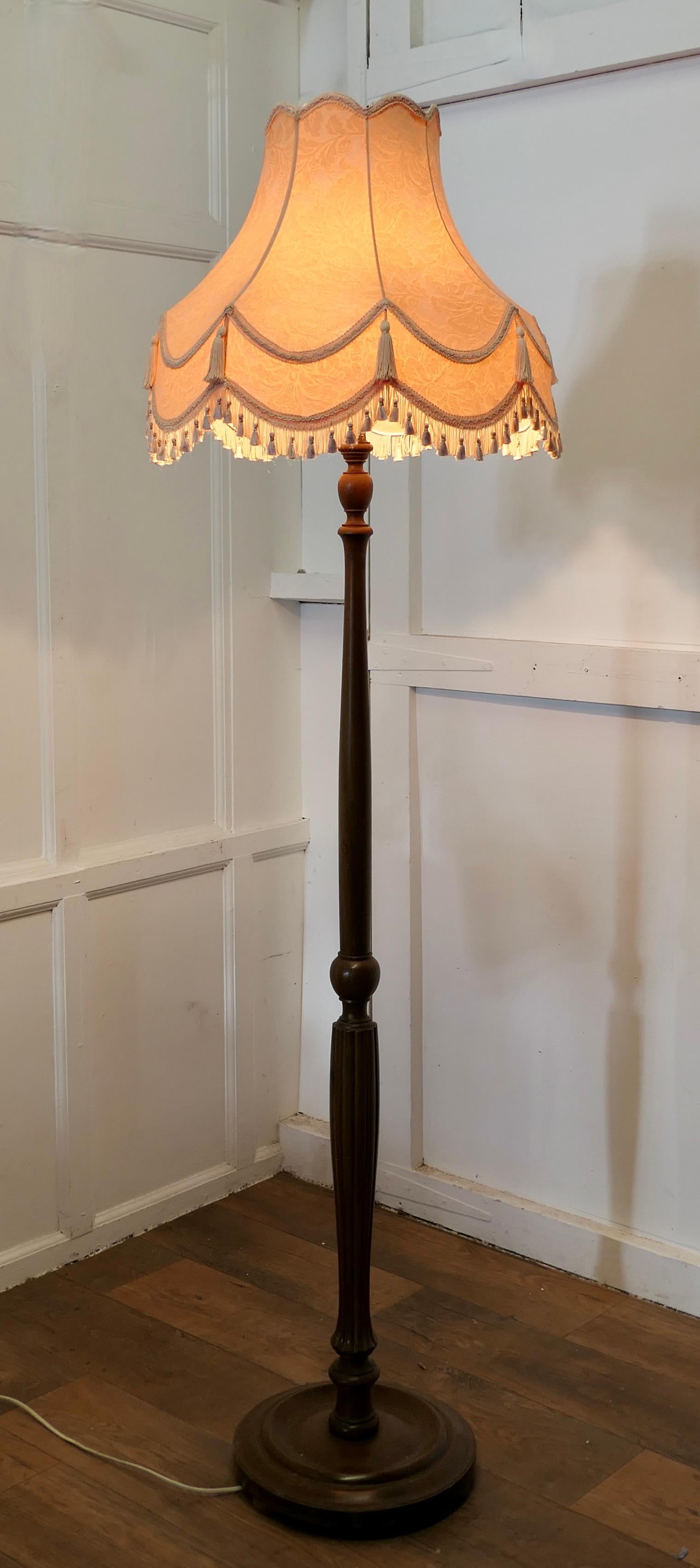  Superb Turned and Fluted Standard or Floor Lamp 

This is a very stylish piece, the turned walnut base supports a shaped and fluted central column
The lamp is in good condition, working and with a charming Peach brocade fringed lamp shade
The lamp