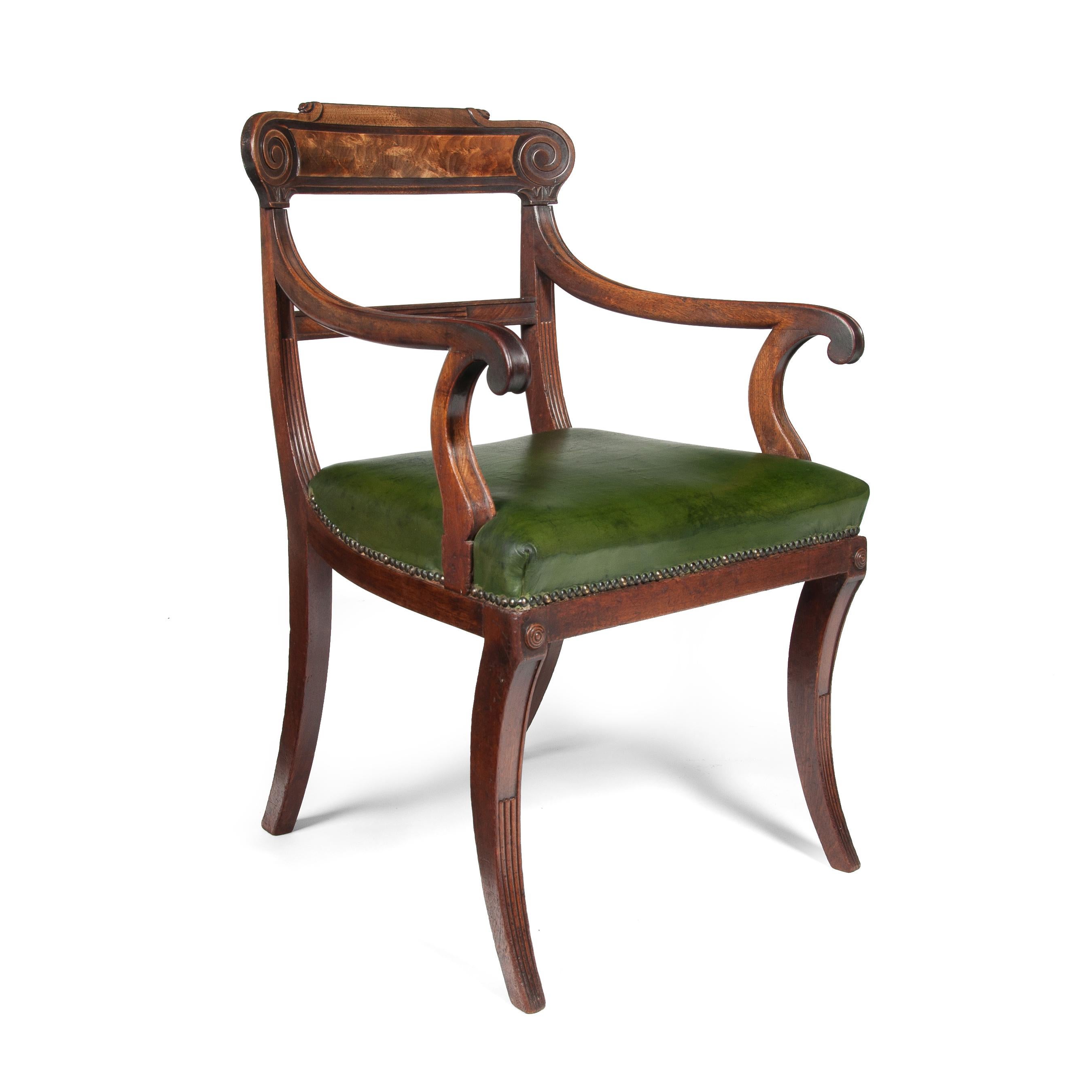 A superb Regency mahogany open armchair with the timber in untouched condition having a later green leather seat,

English, circa 1810.

Of Grecian form, the curved top rail with a paper scroll over a panelled centre flanked by vitruvian scrolls