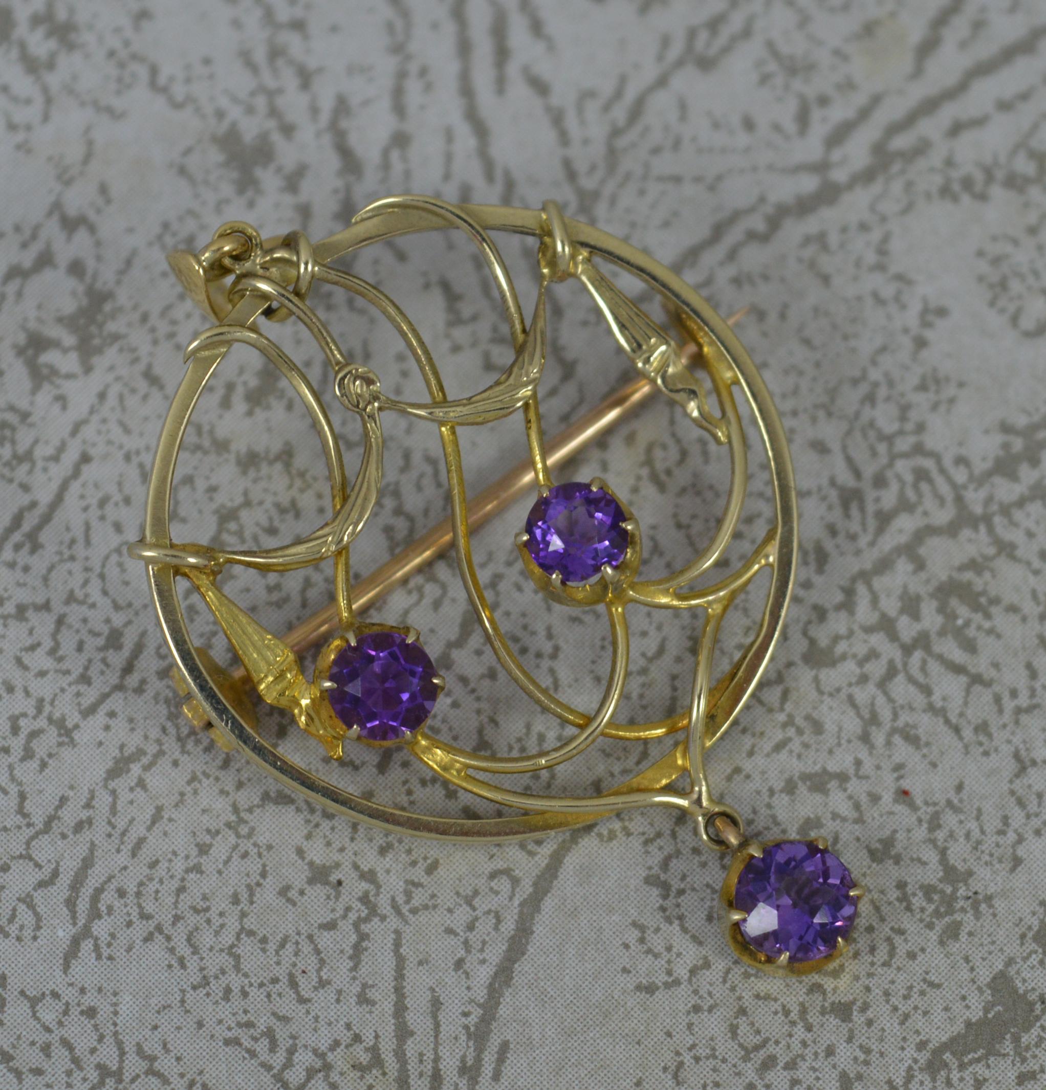 A very stylish Edwardian period pendant.
Designed with a draped pierced circular shape to centre set two amethyst stones and a final amethyst drop to base.
Solid 15 carat yellow gold example.

CONDITION ; Excellent. Crisp design. Well set stones.