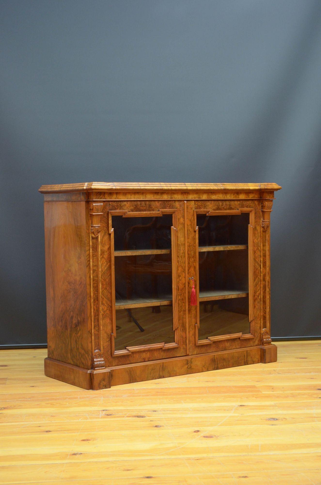 Sn5353 Fine quality and very attractive, Victorian walnut bookcase or display cabinet, having figured walnut top above a pair of glazed door enclosing original, lined interior with two shelves and fitted with original working lock and a key, flanked