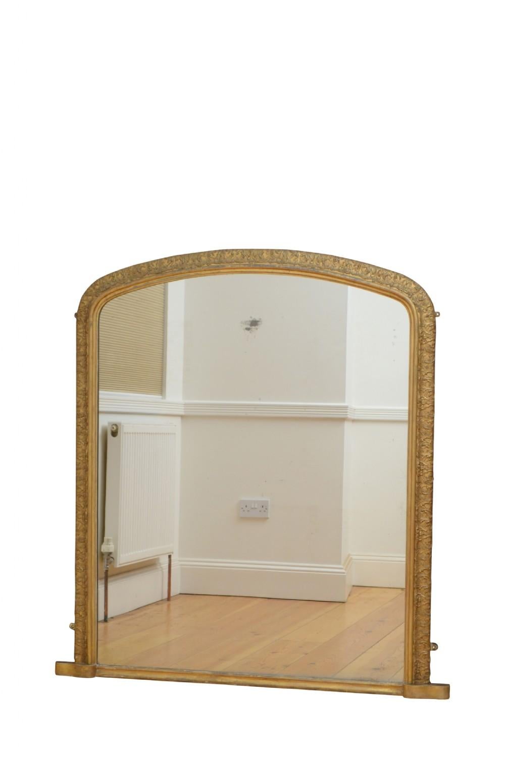K0330 Exceptional Victorian gilded overmantel mirror, having original glass with some foxing in scroll and foliage decorated gilded frame. This antique mirror retains its original glass, original gilt and original backboards, all in wonderful home