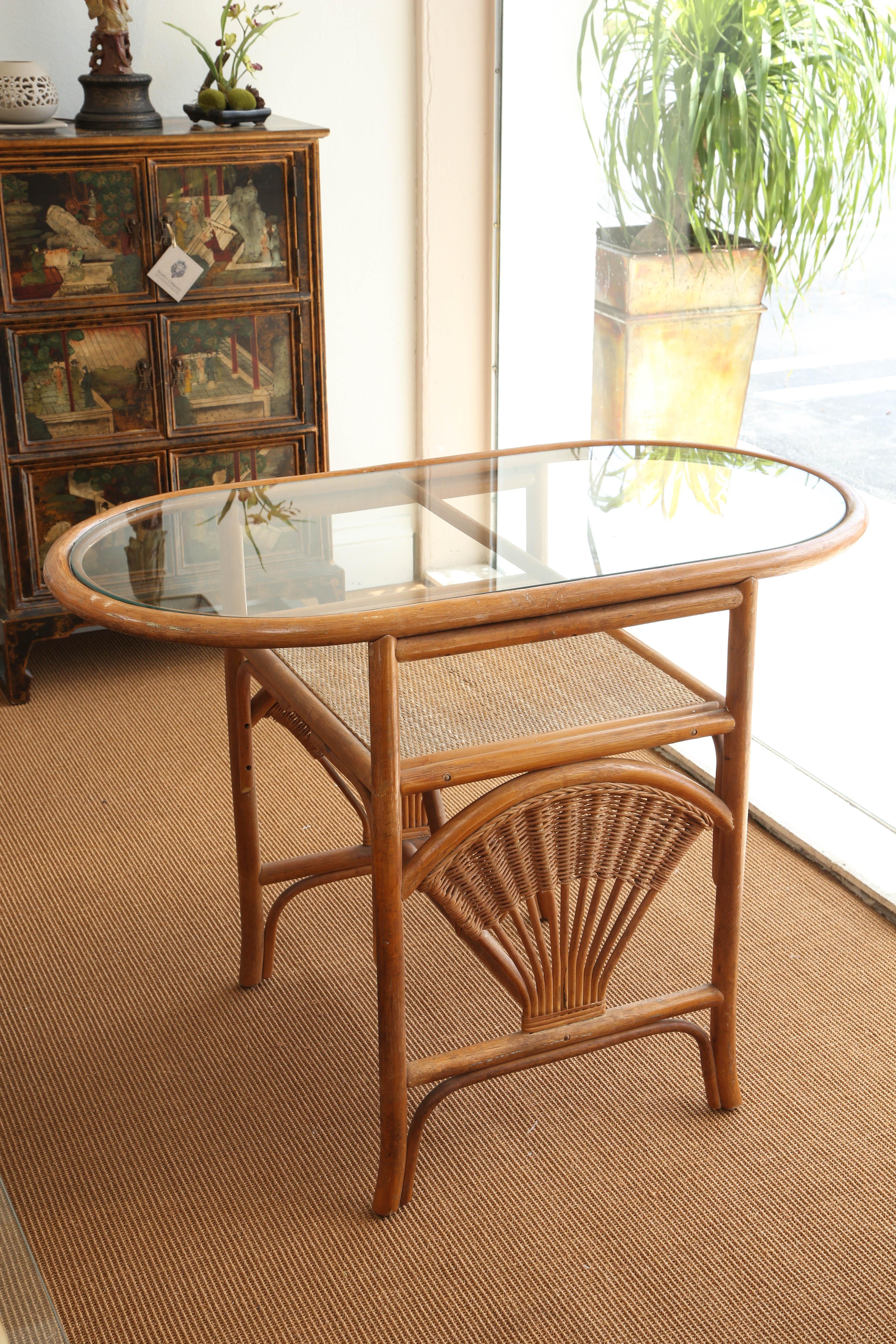 Superb vintage bamboo bistro glass table and rattan with two upholstered chairs.
Measures: Chairs are H 27.5 W 28 D 18 and seat high 18.5.