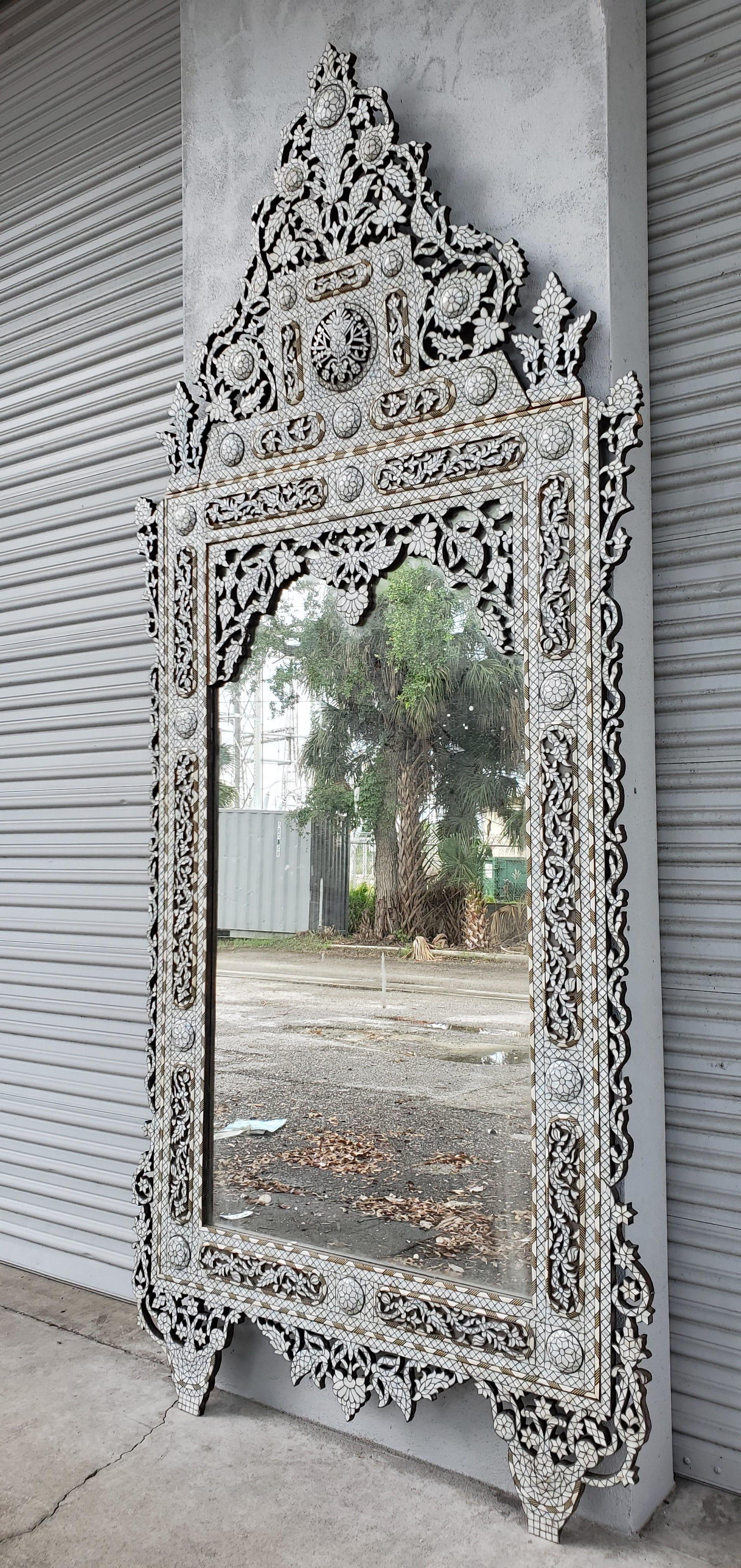 This vintage handcrafted inlaid mirror is crafted from individuality cut pieces of mother of pearl and camel bone. The high bonnet top is geometric style design is detachable for easy transport.