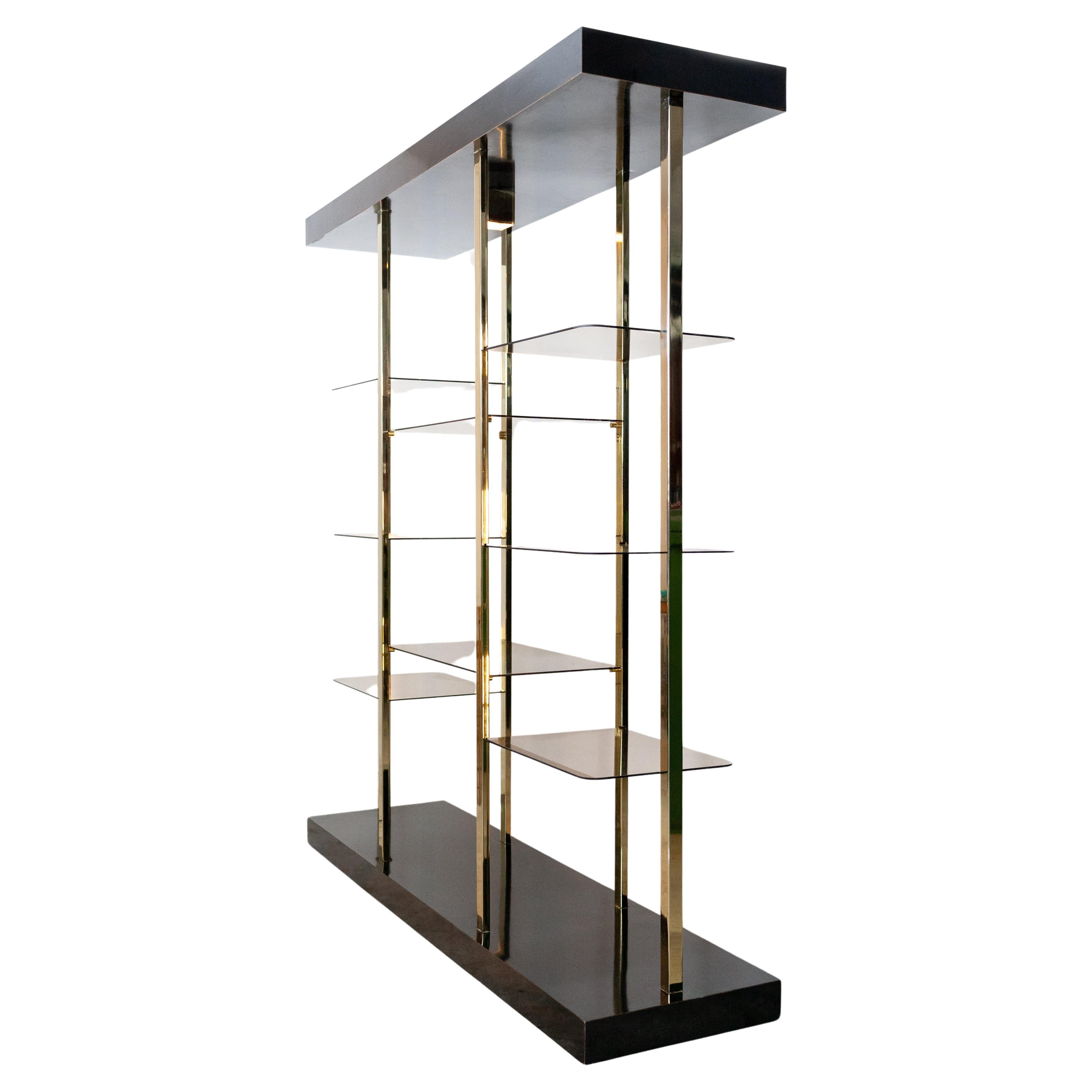 Superb elegant looking Vitrine cabinet. Black high gloss top and bottom, brass uprights and eight smoked glass shelves. Nice quality. BelgoChrom Belgium 1970s two uprights have build in lighting. so stylish 
There is also a brass spotlight in the