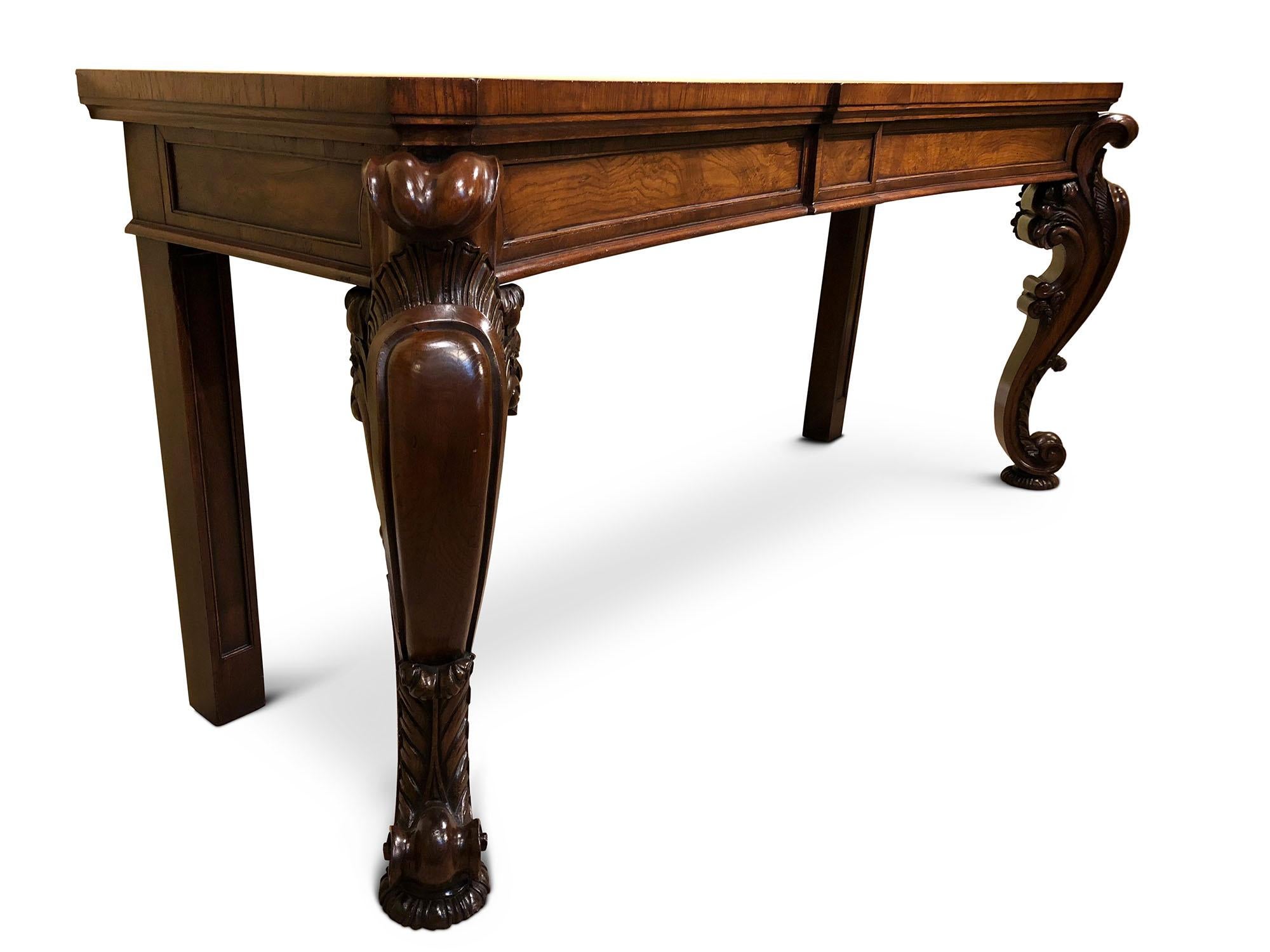 Superb William IV concave oak serving table, circa 1835
Crossbanded concave top with central breakfront frieze. Spectacular carved scrolled cabriole legs resting on flat Mellon feet.
 