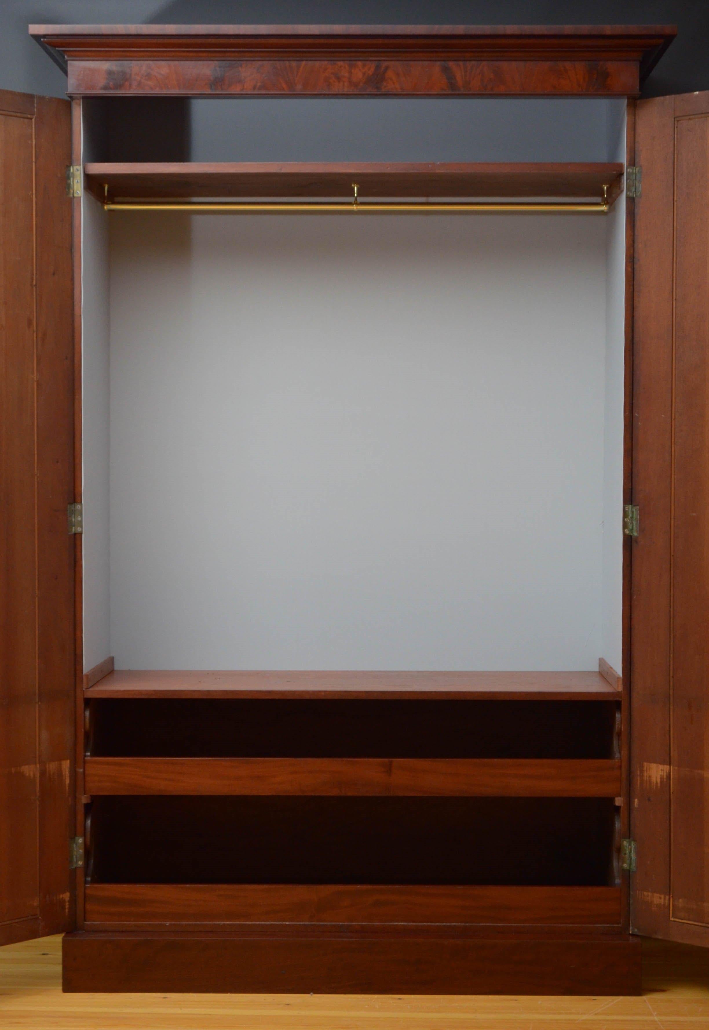 Sn4867, superb William IV, two-door wardrobe in mahogany, having cavetto cornice above a pair of flamed mahogany doors with arched mouldings, fitted with original working lock and a key and enclosing shelf, hanging space and 2 sliders, all flanked