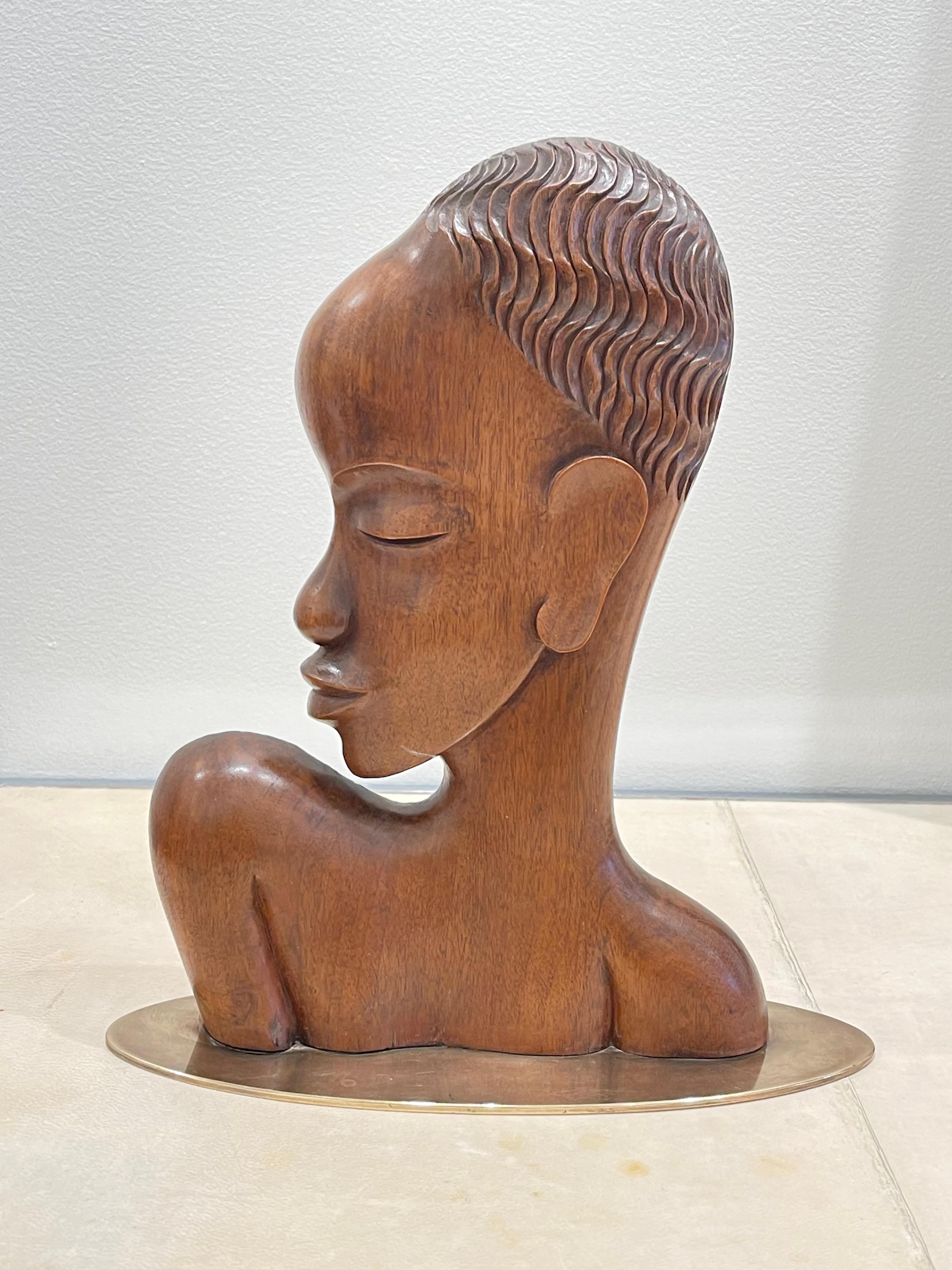 Very rare wooden sculpture (cherry tree wood) of an African lady by Karl Hagenauer (1898-1956). it is carved as a profile, made out of a single piece of wood on a flat oval brass base. This piece was carved circa 1930.
Signed under the base