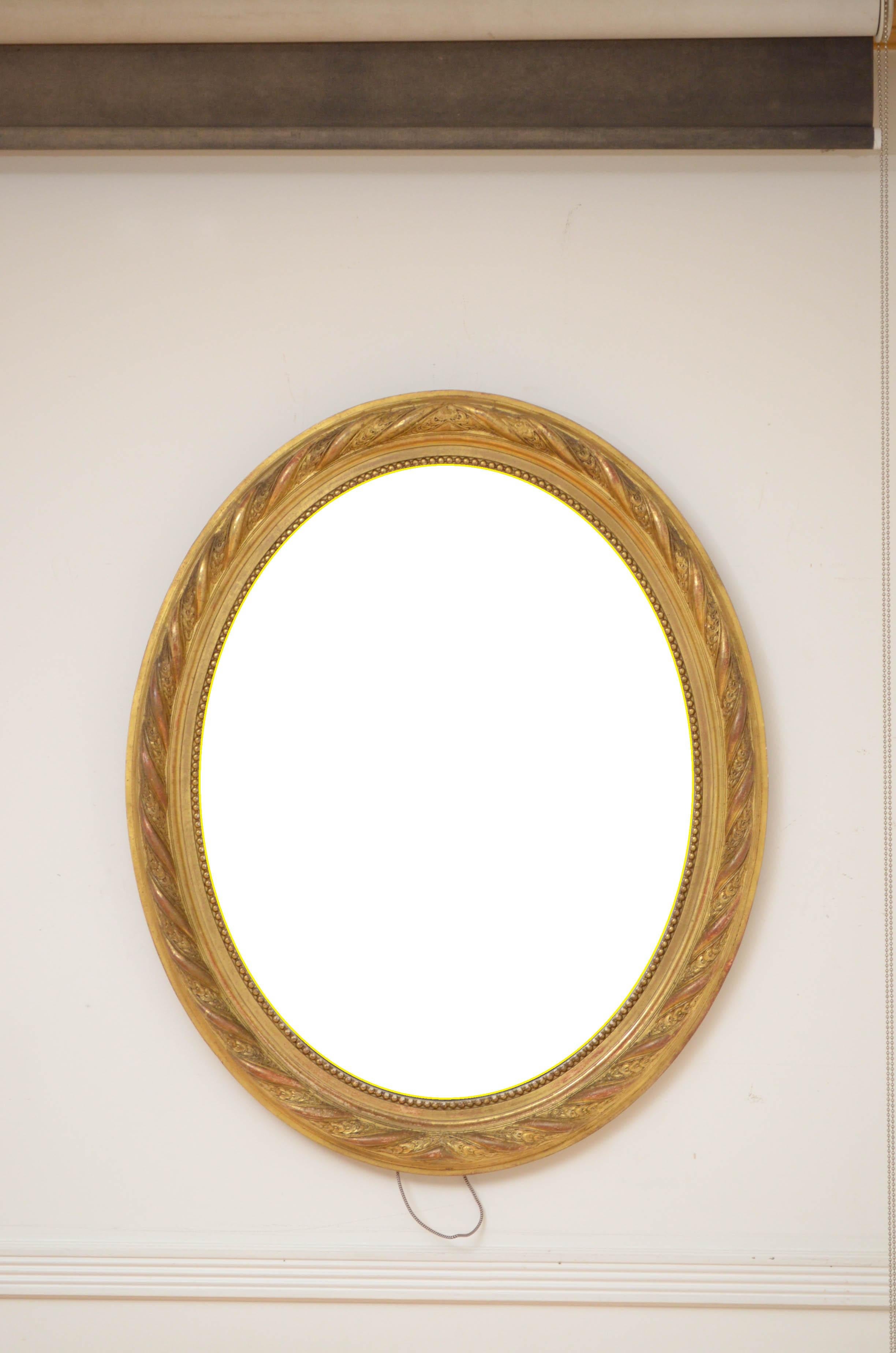 0583 Superb 19th century gilded wall mirror, having original bevelled edge glass with some foxing in beautifully carved and beaded giltwood frame. This antique mirror retains its original glass, original gilt and backboards, all in home ready
