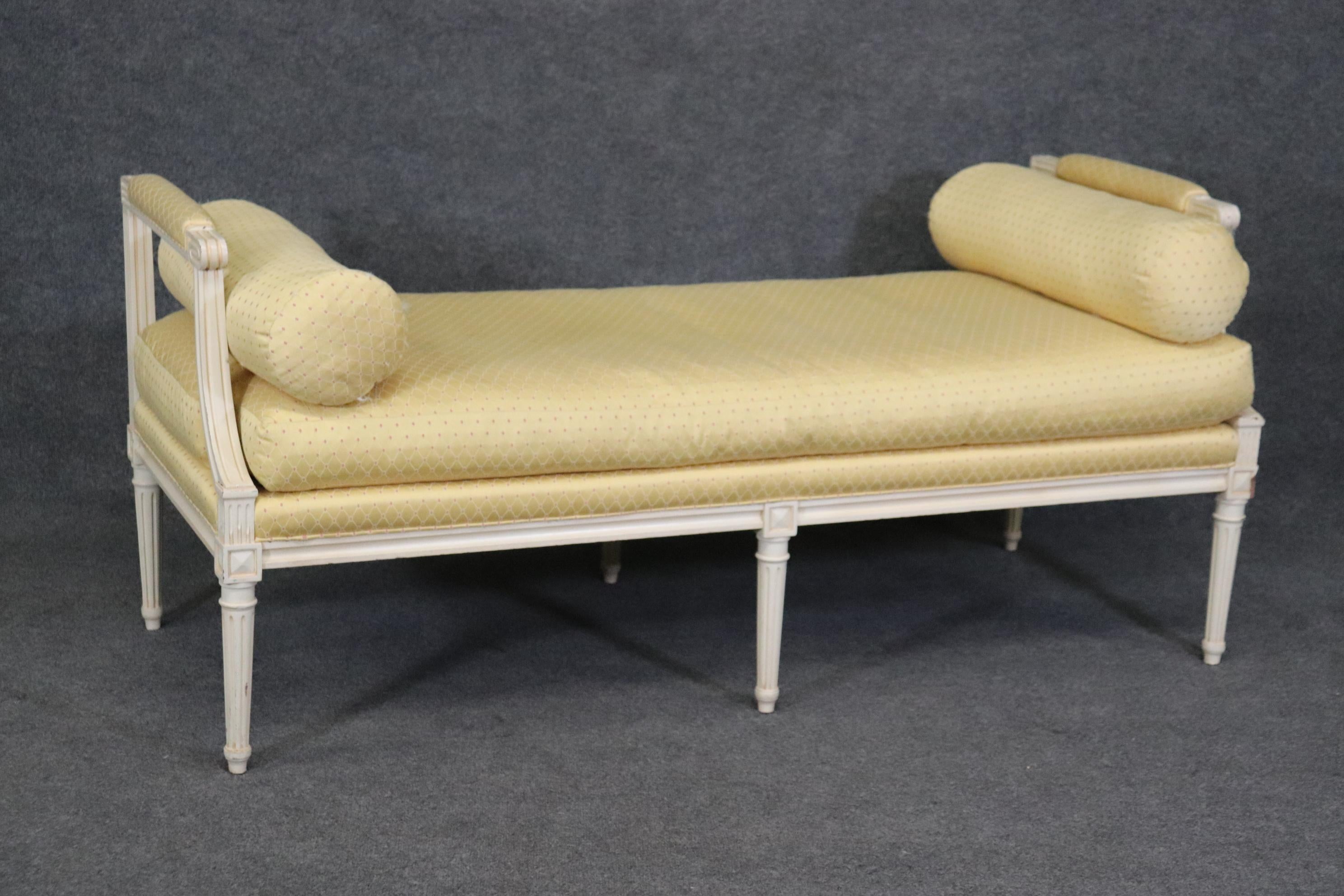 This is a fantastic, super clean bright yellow and bright white French louis XVI style window bench with clean lines and simple beautiful yellow upholstery. The piece has minimal signs of wear and use and dates to the 1950s. Measures 28.75 tall x