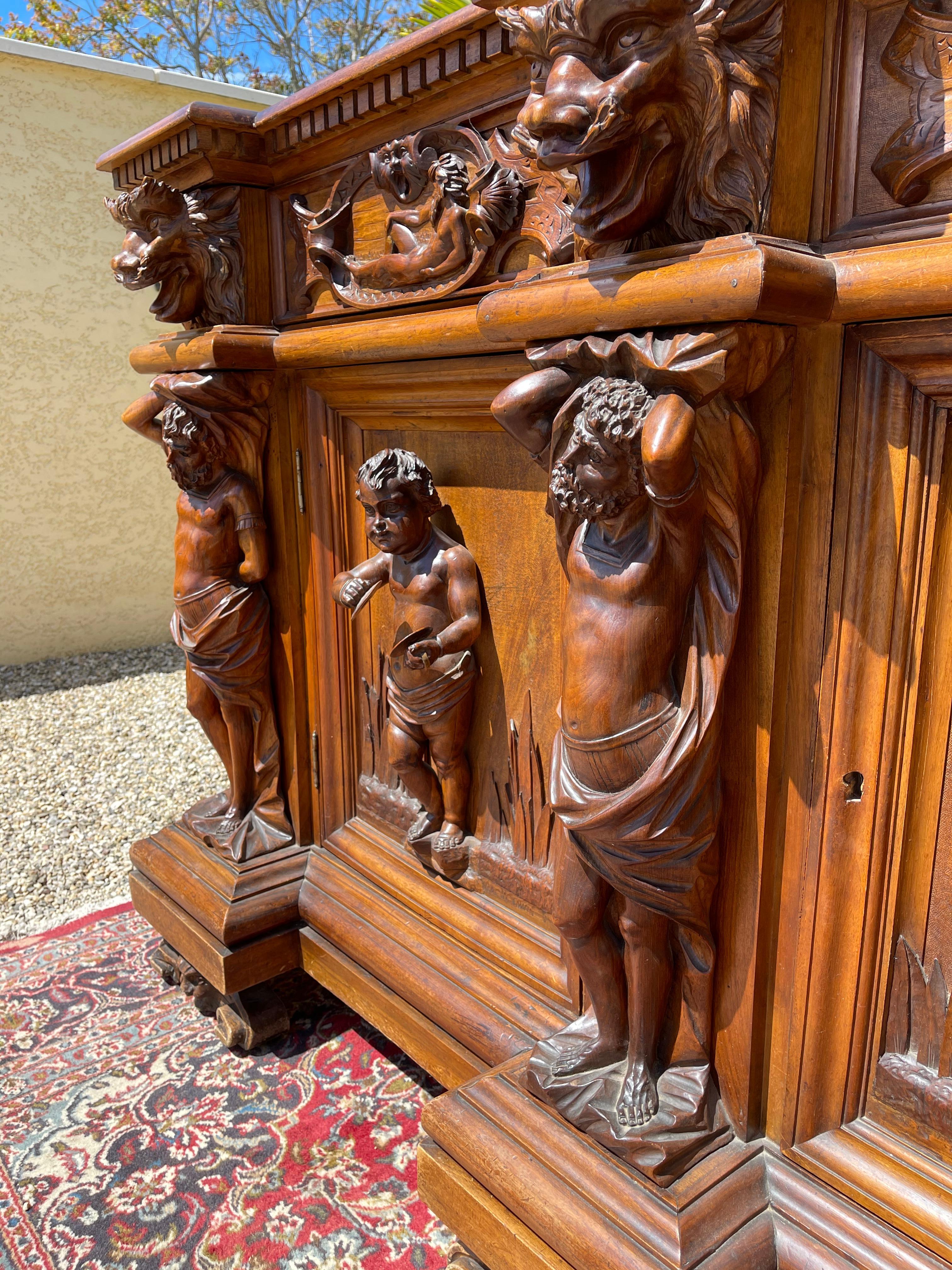 Superb richly carved walnut sideboard in Italian style. This row opens with 7 drawers and 3 doors. Beautiful work of sculpture and good condition. Top Quality.