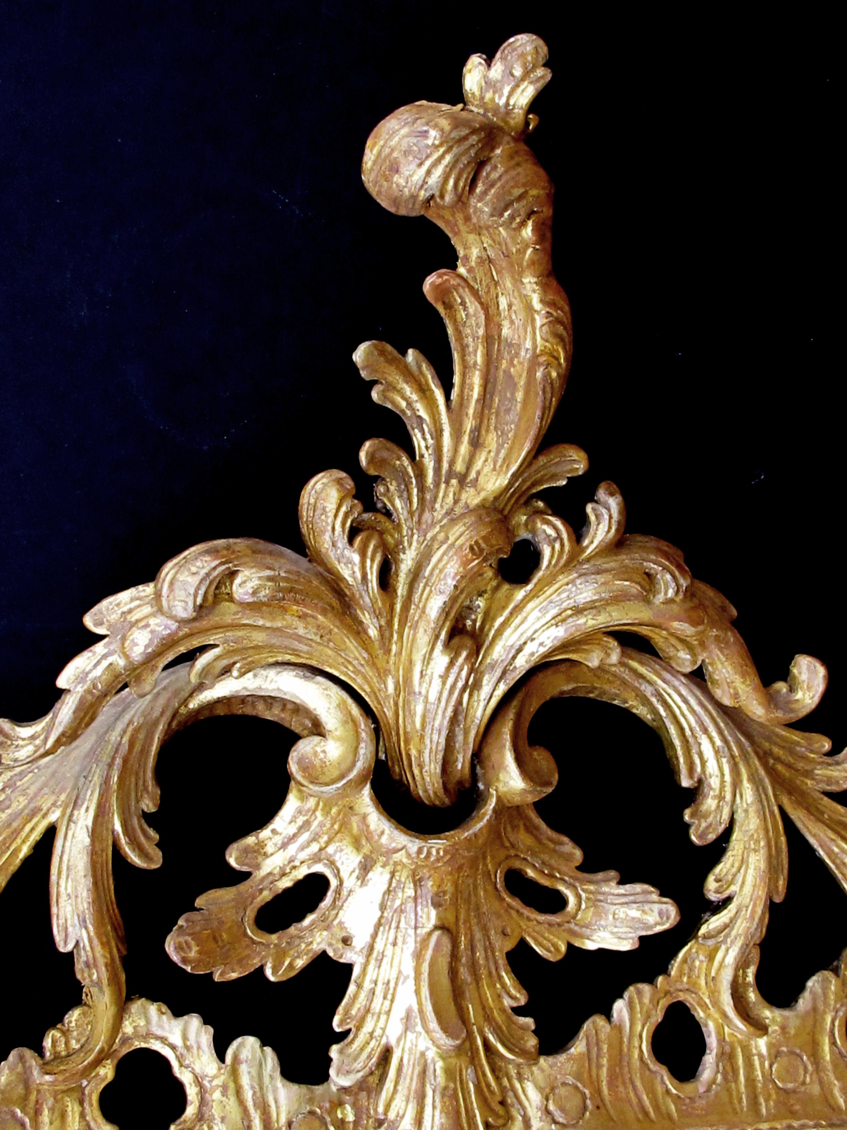 Superbly-Carved English George II Giltwood Mirror with Elaborate Foliate Crest In Excellent Condition In San Francisco, CA