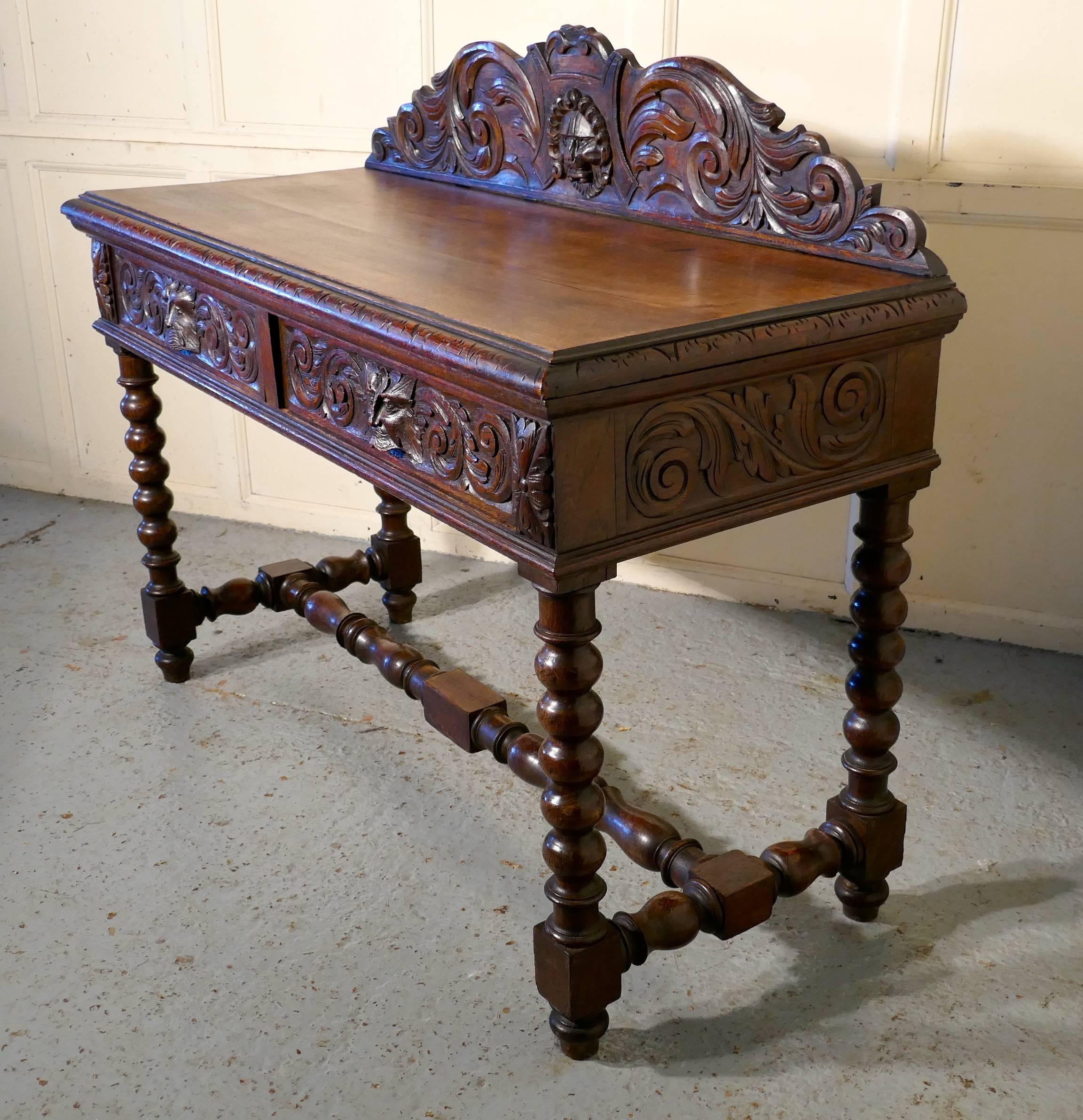 Superbly carved green man oak hall table.

The table is made in solid oak, the carved gallery at the back of the table has a fearsome mask of the green man in the centre, the table top has beautifully carved moulded edge, below we have two drawers