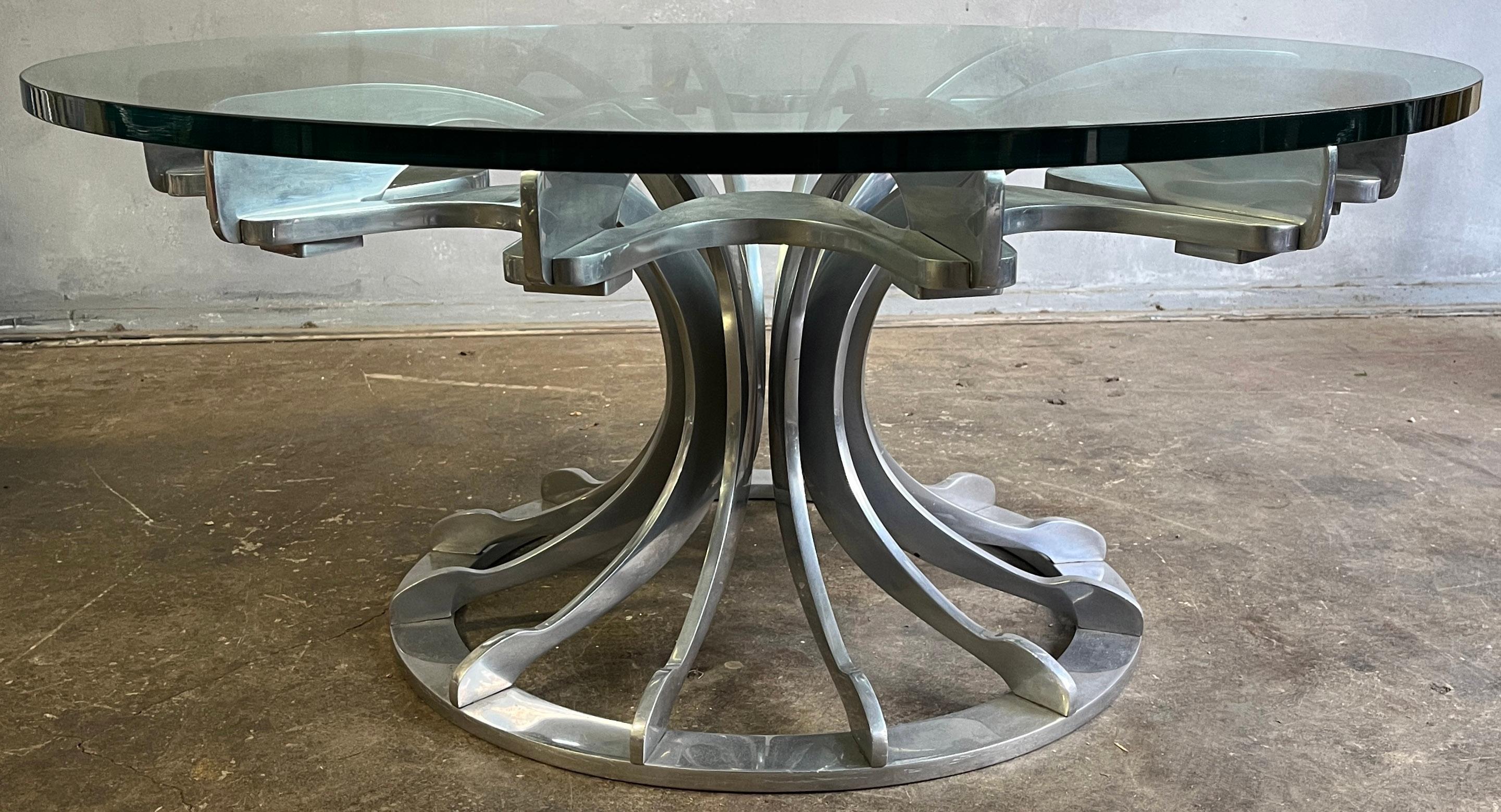 Incredibly engineered and designed Modern coffee table. Individual casted aluminum parts skillfully composed to crafted a flower pedestal base. 3/4 round glass is in excellent condition. Near mint. Unique piece