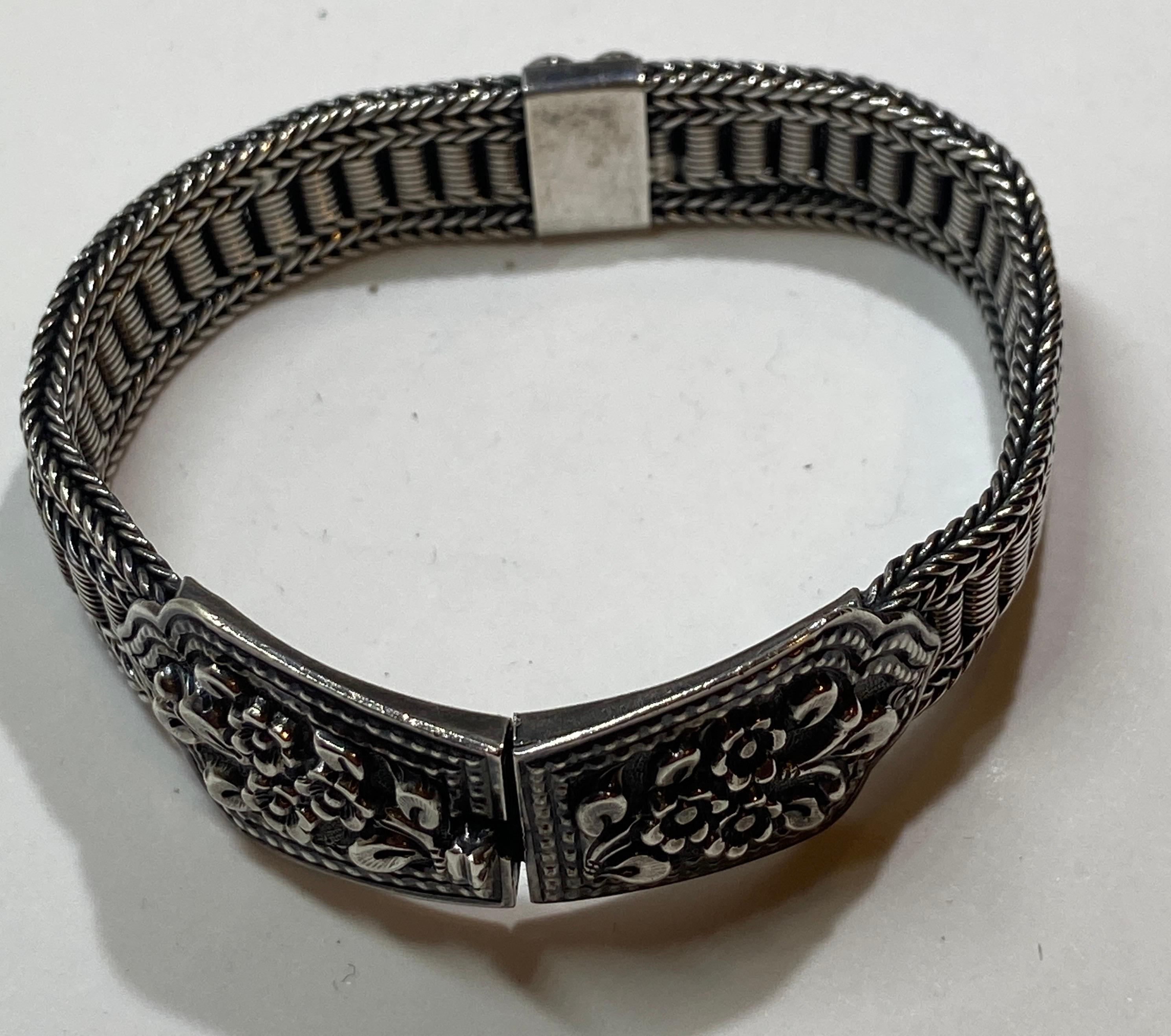 This superbly detailed victorian sterling silver with floral accents clasp bracelet measures 7 1/2 inches in length. The width measures 1/2 inch to 6/8 inch. woven and finely braided throughout, the opening clasp has a 'click'. Interior is etched