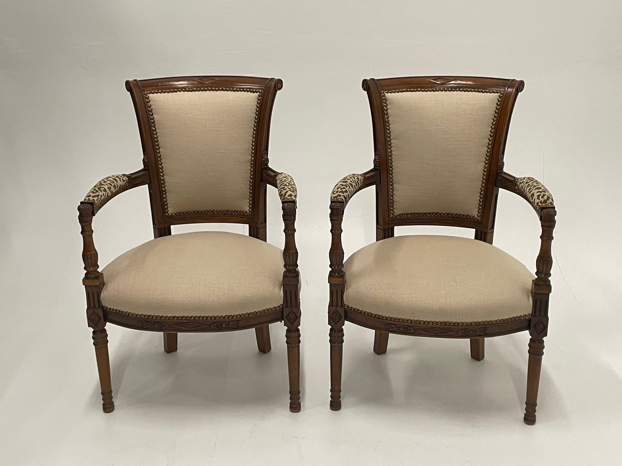 Elegant updated pair of French carved walnut armchairs tastefully and stylishly upholstered in oatmeal linen and coordinating cotton leopard fabric, masterfully finished with brass nailheads in all the right places.
Arm height 25.