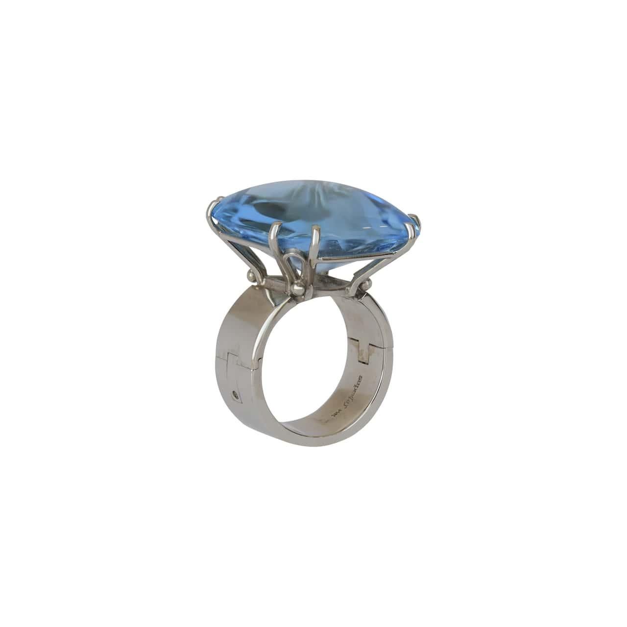 This bold and eye-catching ring by SuperFit features a square cabochon blue topaz with a faceted bottom, elegantly secured by 8 prongs and set in lustrous 14K white gold. The blue topaz itself is an impressive 1 inch by 1 inch in size, boasting a