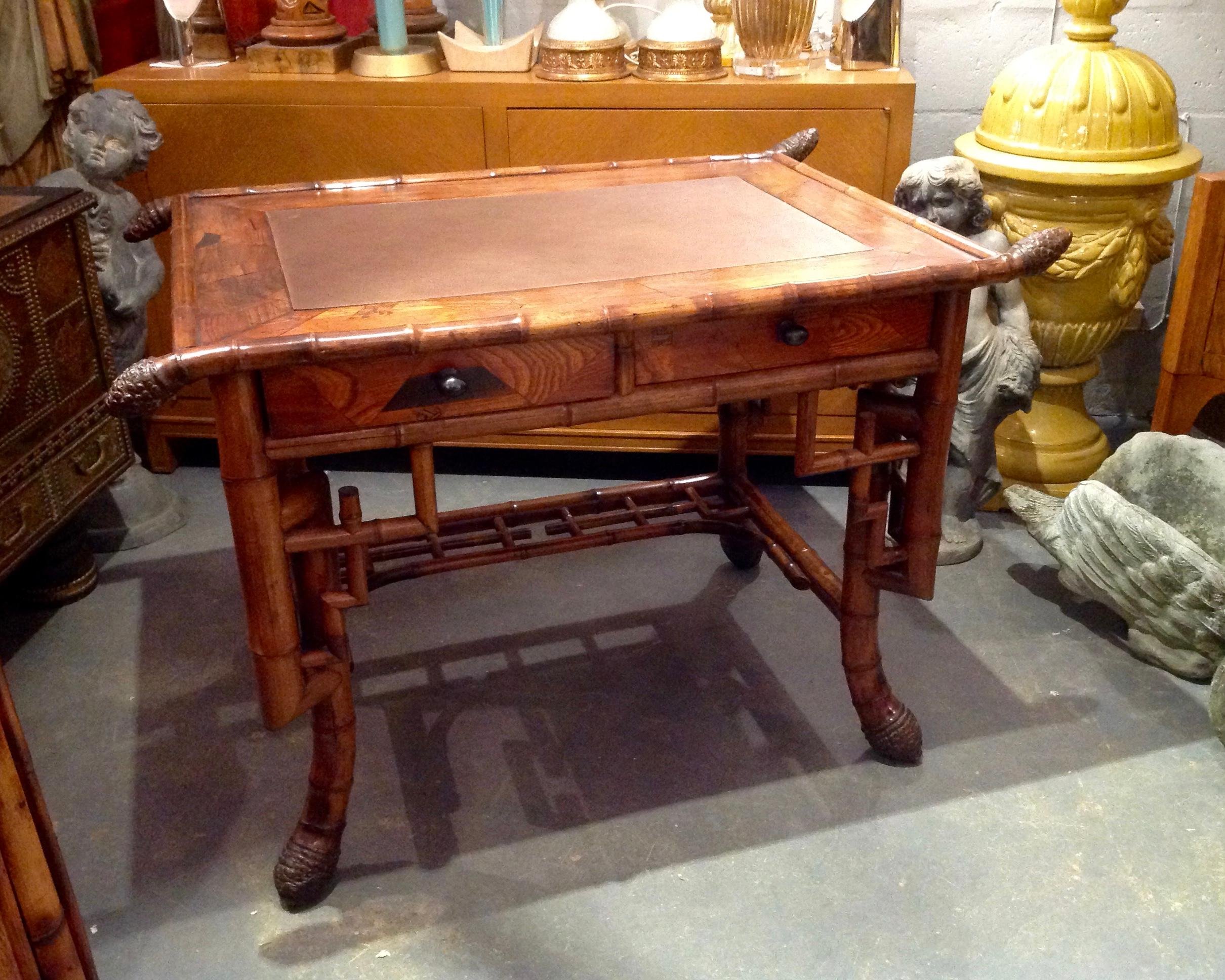 Superb quality and stylized bamboo appointed with inlays and a leather top.
The desk is fashioned with 2 drawers and terminates with massive root feet.
This aesthetic era piece may possibly be one of a kind.