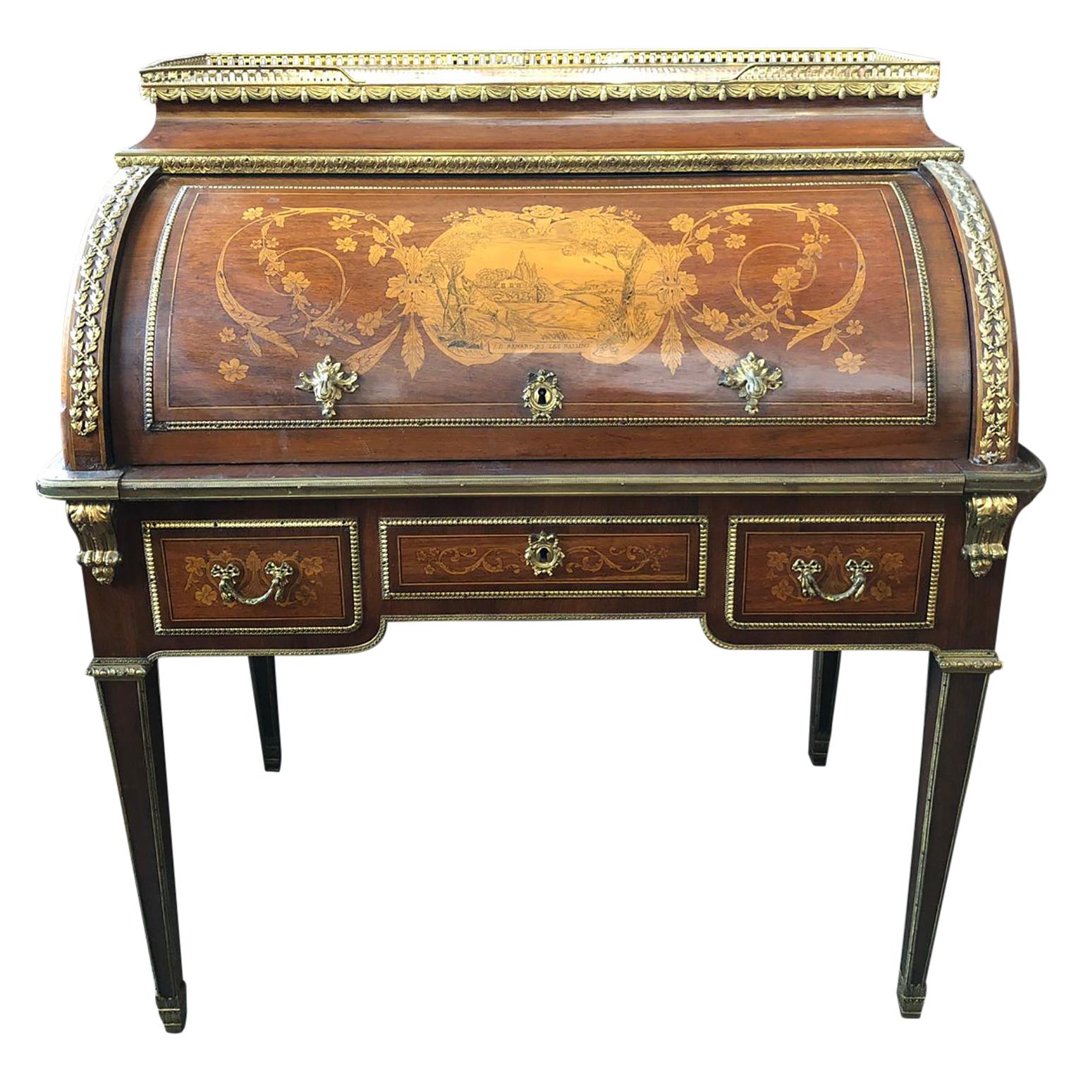 Superior 19th century French Louis XVI style parquetry/marquetry cylinder desk. It has a pierced brass galleried top over a stunning foliate and lyre inlaid parquetry cylinder which encloses a fitted interior with three drawers and a pull out /