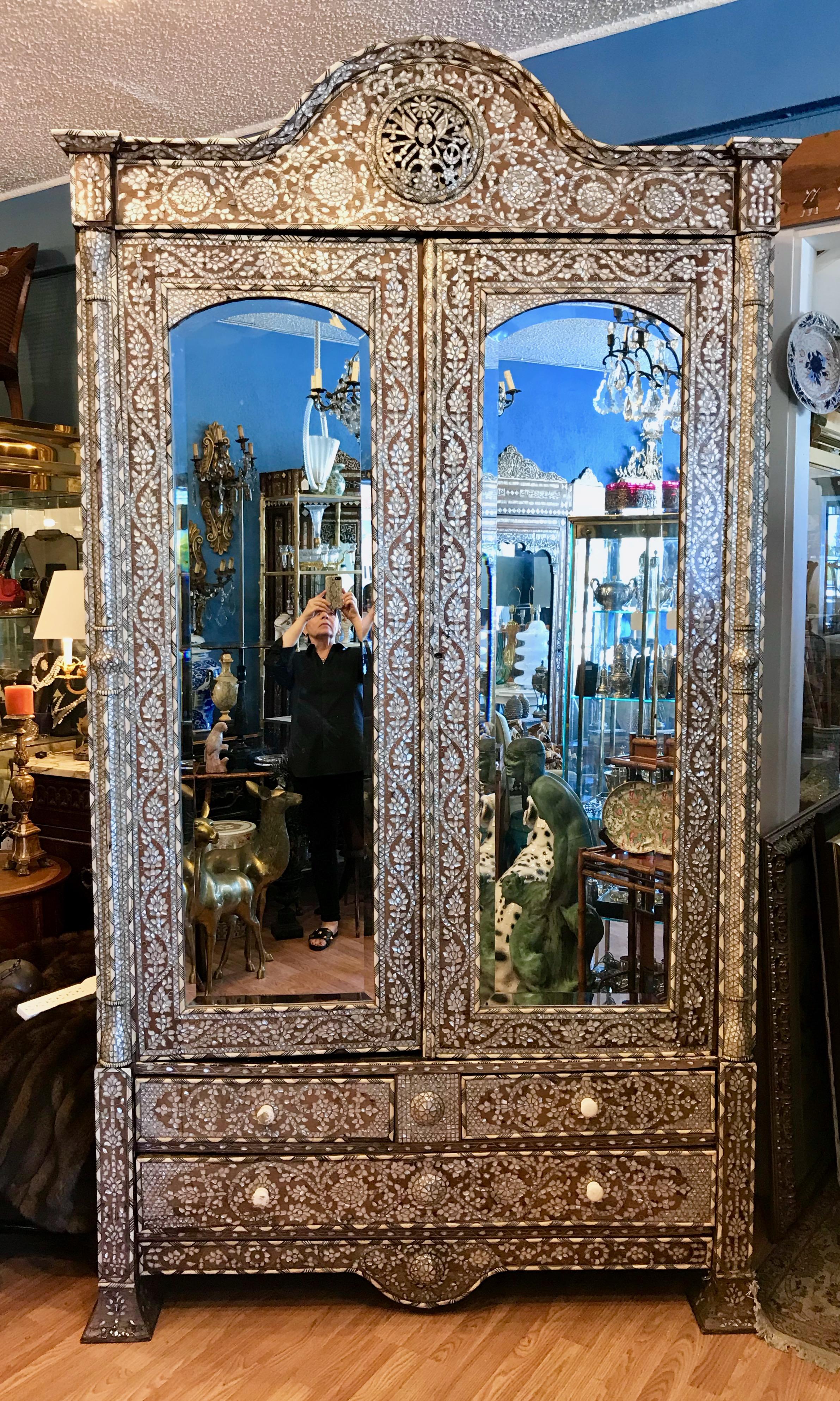 The finest quality ! Absolutely stunning ! 
Fashioned with intricate inlays of mother of pearl surrounded 
by metals inlays. The piece is in a remarkable state of preservation.
The interior is fitted with removable shelving unit - preserving the