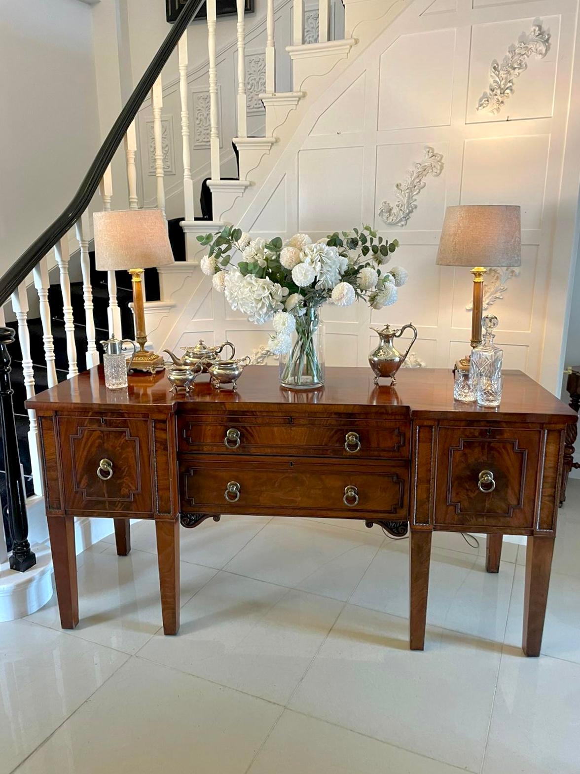 Superior quality antique Regency mahogany sideboard with an exquisite mahogany inverted breakfront top, two long cutlery drawers to the front flanked either side by a wine drawer and a cupboard door all with original brass handles. It has beautiful