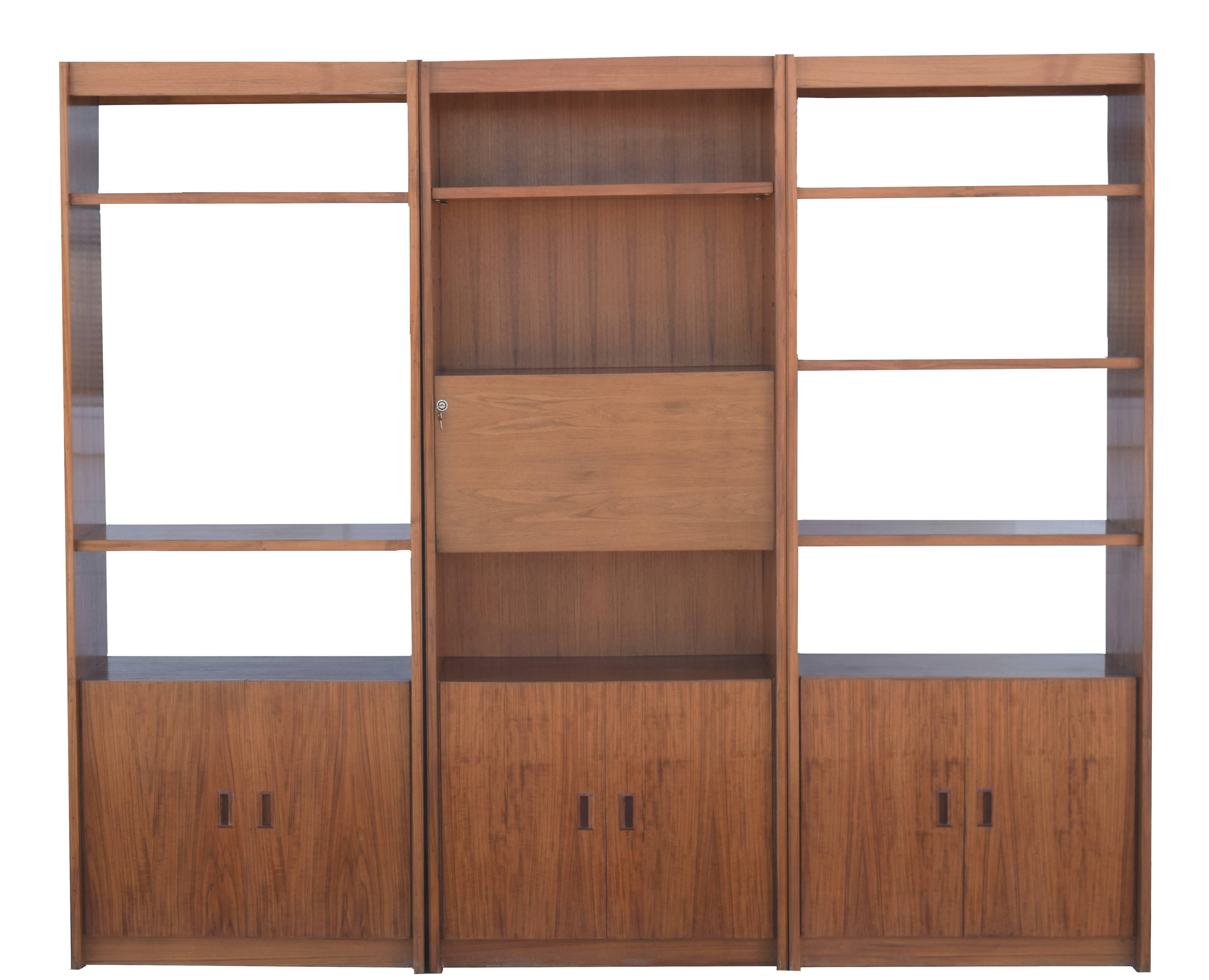 Denmark, circa 1970
Teak, locks, mirrored interior
Each 33 wide x 83.5 tall and 16.5 inches deep
Overall 99 wide, 83.5 tall and 16.5 inches deep

One of a kind vintage custom made bookcase and cabinets with the designer and maker unknown, produced