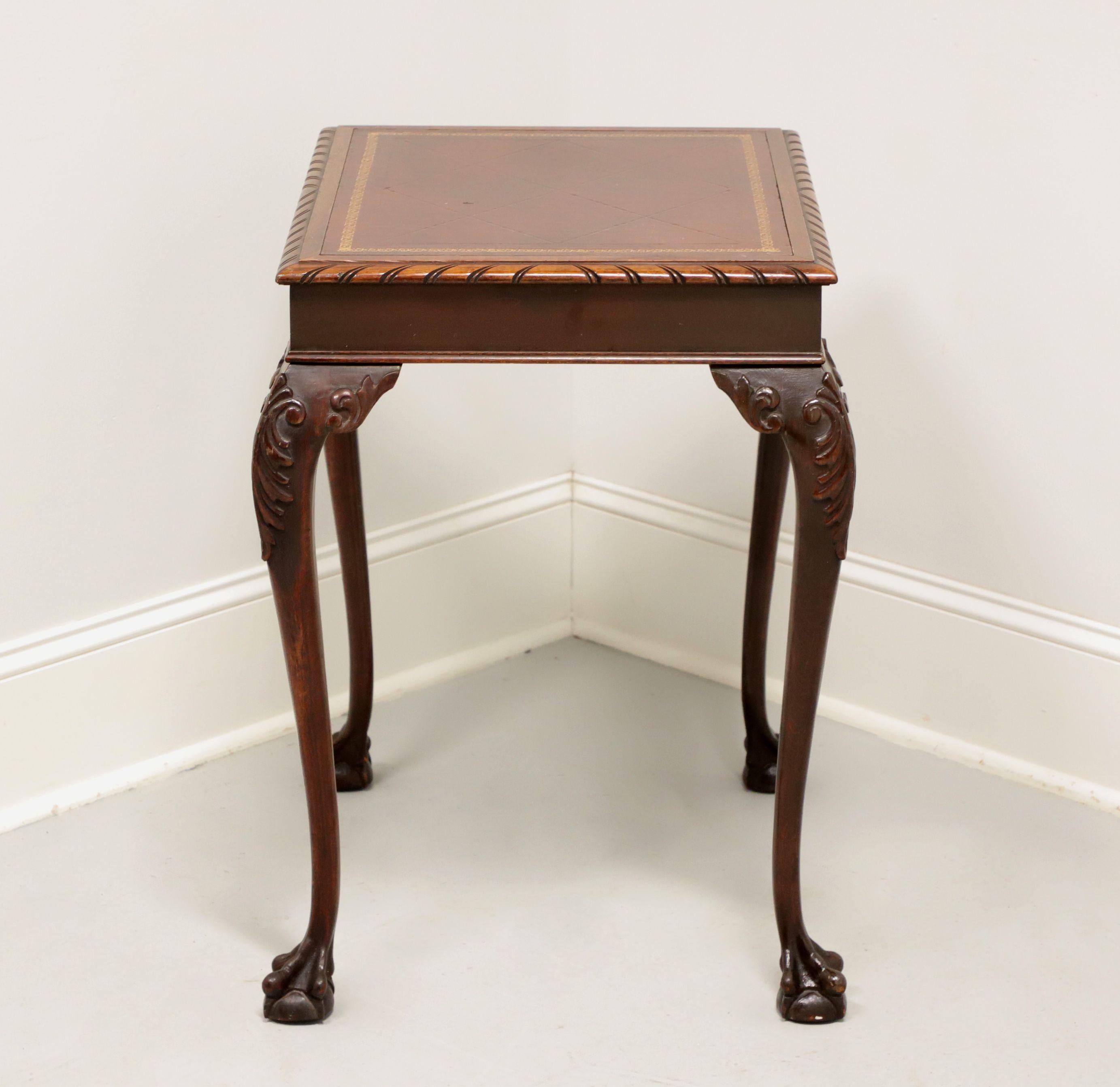 A Chippendale style rectangular side table by Superior Table, now part of Kindel Furniture. Solid mahogany, embossed leather top with gadroon edge, ogee edge to apron, carved acanthus leaves to knees, cabriole legs and ball in claw feet. Made in