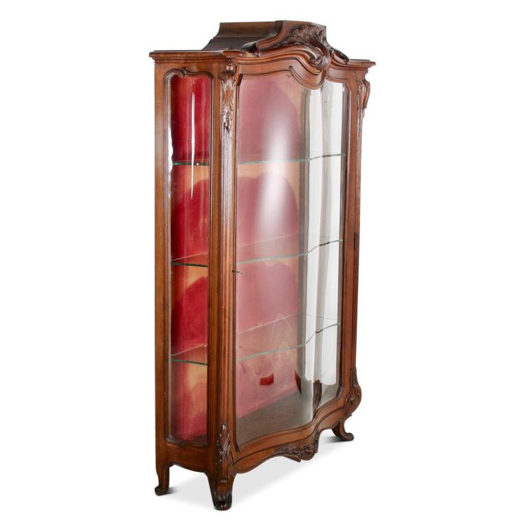 Fine example of French cabinetmaking. The cabinet is early 20th century and is transitional from Victorian to Art Nouveau with both periods clearly defined in the design. From the serpentine bevelled glass, to the fluid organic lines, this solid