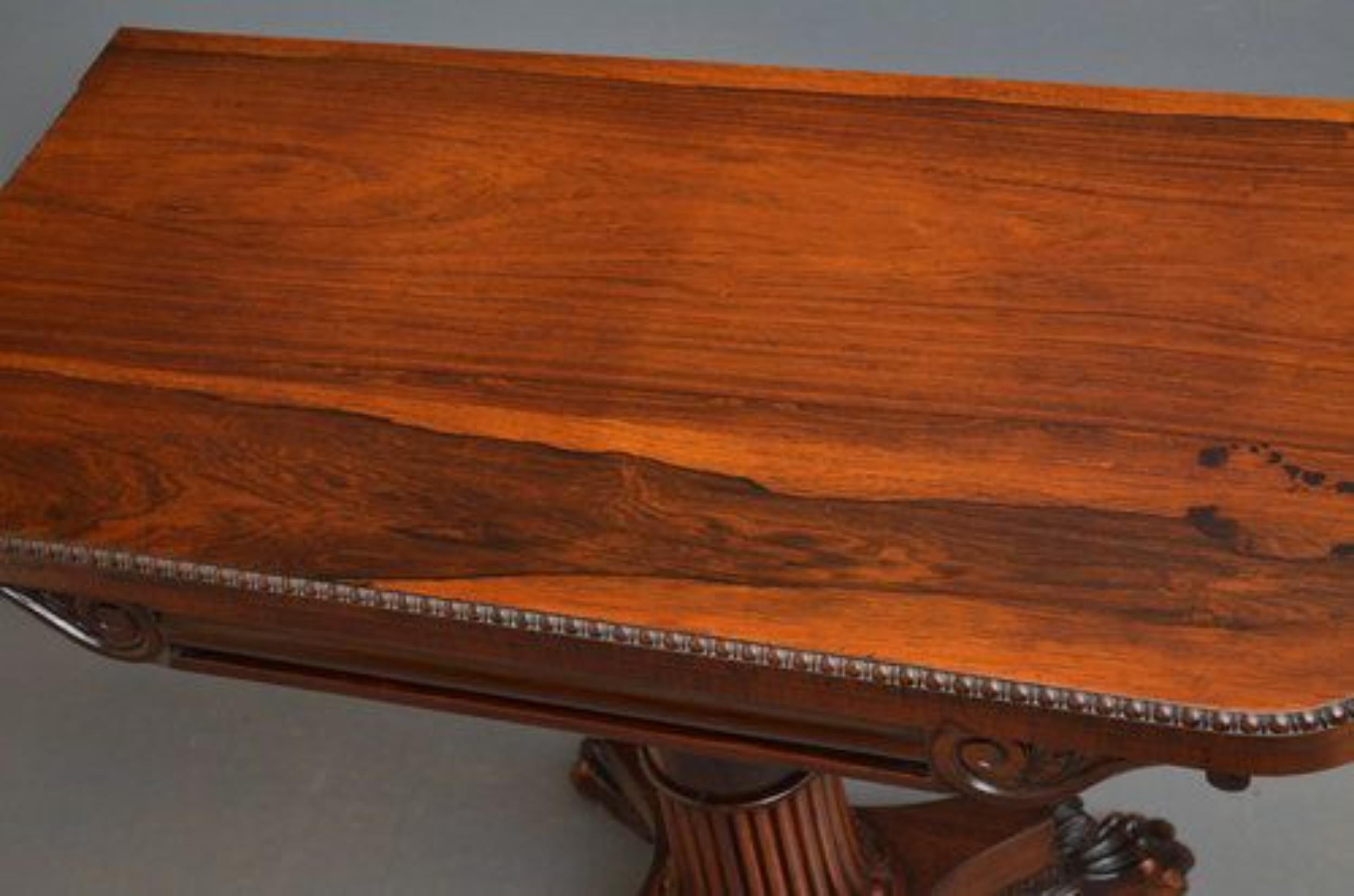 Sn017 Superior quality William IV, rosewood tea table, having stunning top with carved edge, cylindrical frieze flanked by carved leafy scrolls, standing on fluted column terminating in quatrefoil base, paw feet and castors. All in wonderful