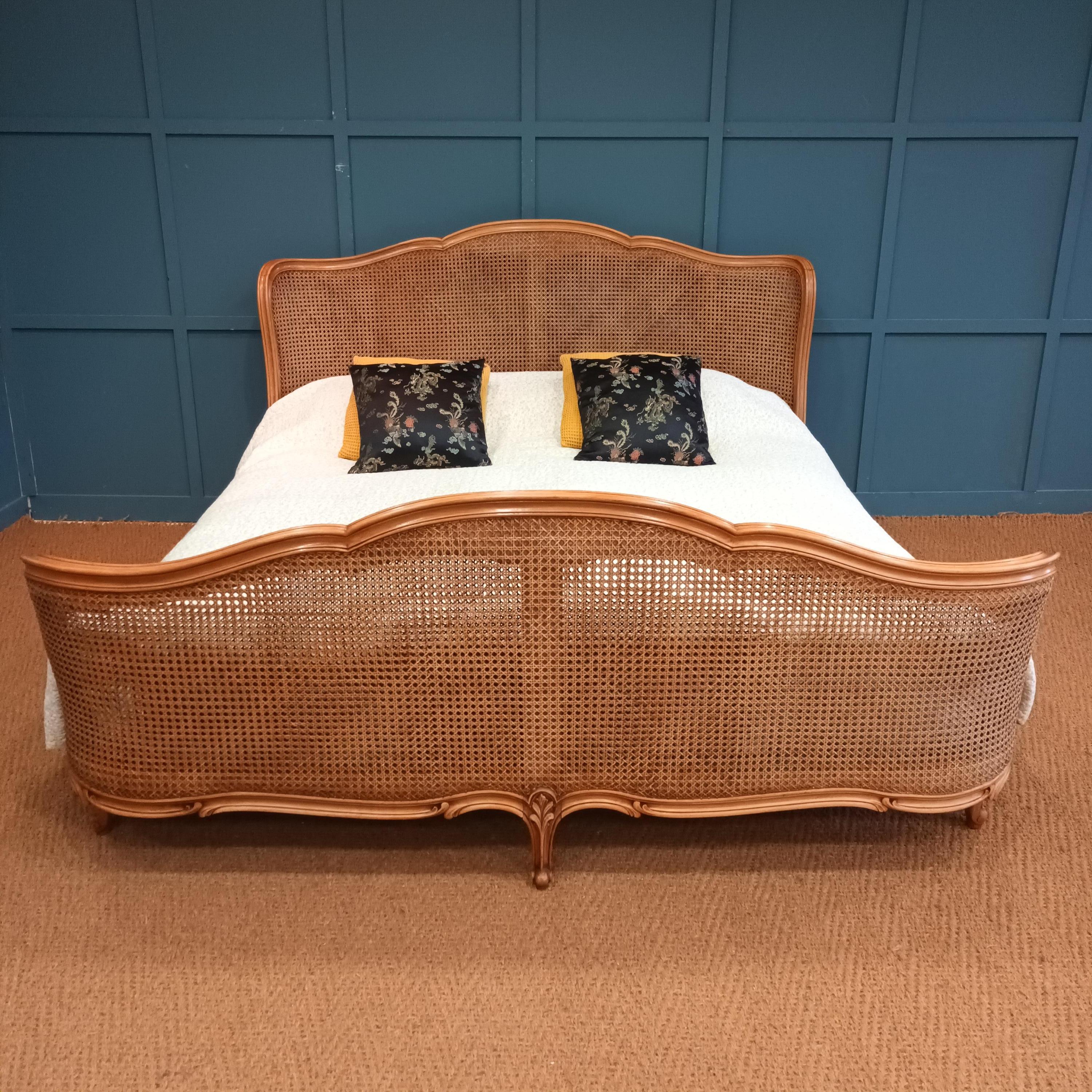 Delightfully elegant French antique bergère bed dating from around the 1900’s. The bed features a full corbeille (both the foot and head ends being curved) and the cane is in perfect condition. The beech frame highlights the cane work and is caned