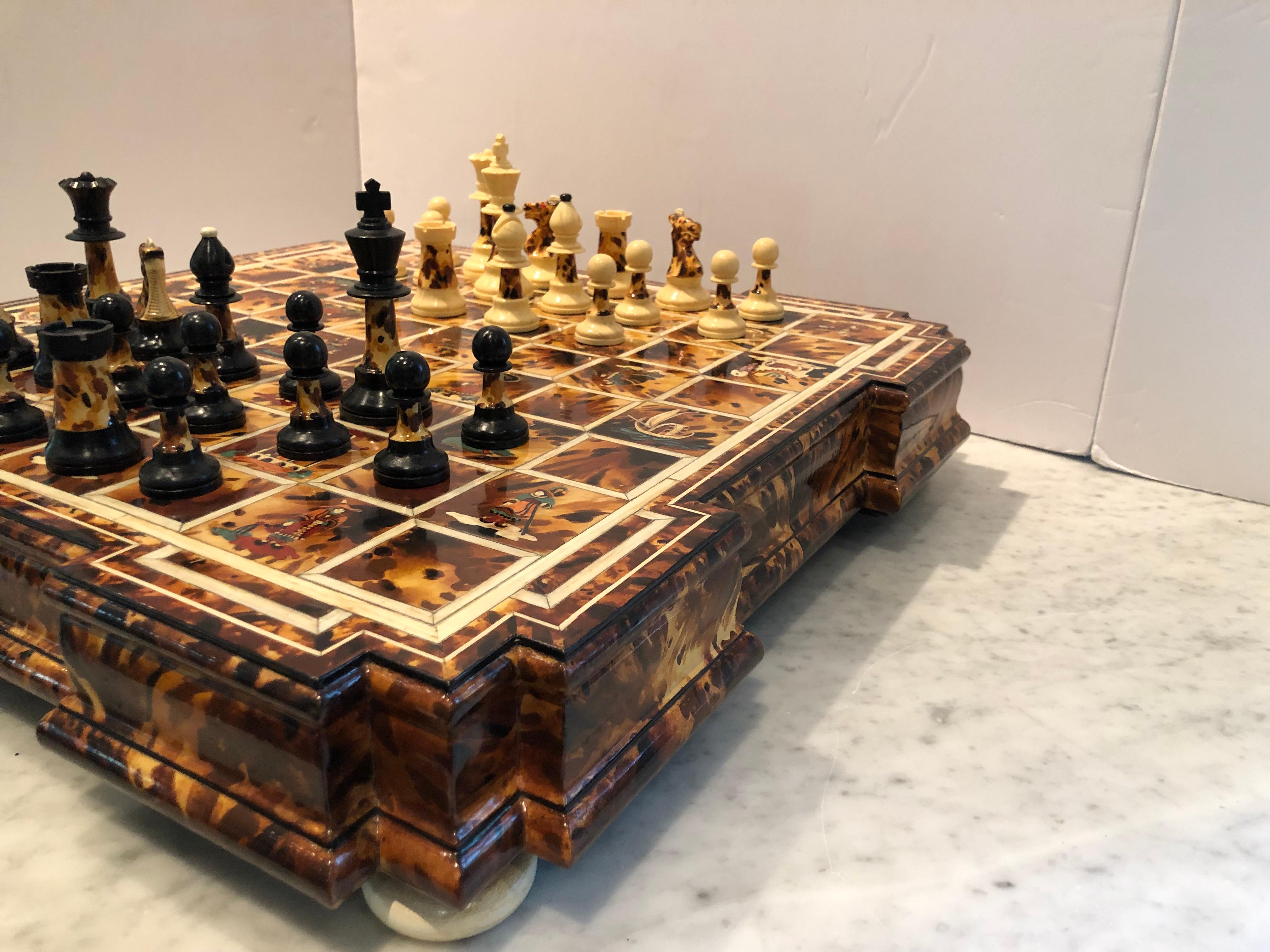 Stunning chess set in faux tortoise shell and inlay. The board has Asian figures and scenes painted throughout in beautiful detail. Lacquered finish. Each chess piece is also painted in a faux tortoise finish.