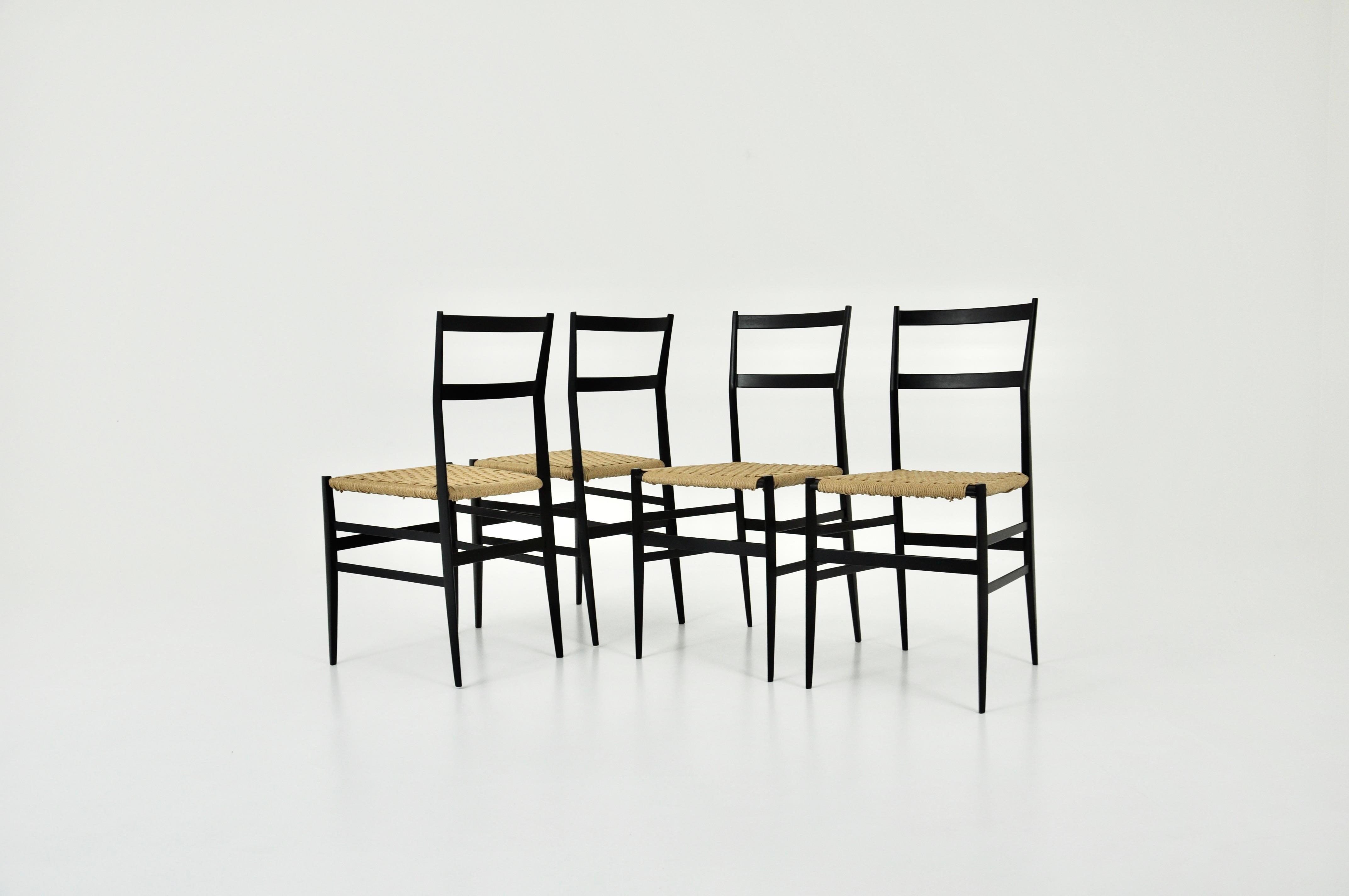 Set of 4 black wooden chairs, rope seat by Gio Ponti. Measures: Seat height 47cm. Wear due to time and age of the chairs.