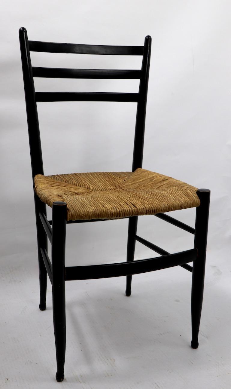 Supperleggra or Spinetto, chair with black wood frame and rush seat, Often attributed to Ponti, marked Made in Italy, and has letters DM ? This example shows cosmetic wear to finish, notably a small nick on the top, as pictured. Original, and ready
