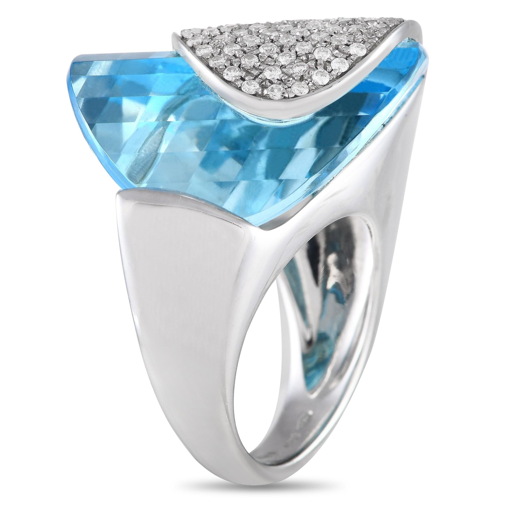 Reflecting Italian creativity, this cocktail ring from Superoro promises superb finger presence. It features a wide, domed band in polished 18K white gold. The top half of the band is embraced by a dazzling light blue topaz in a freeform faceted cut