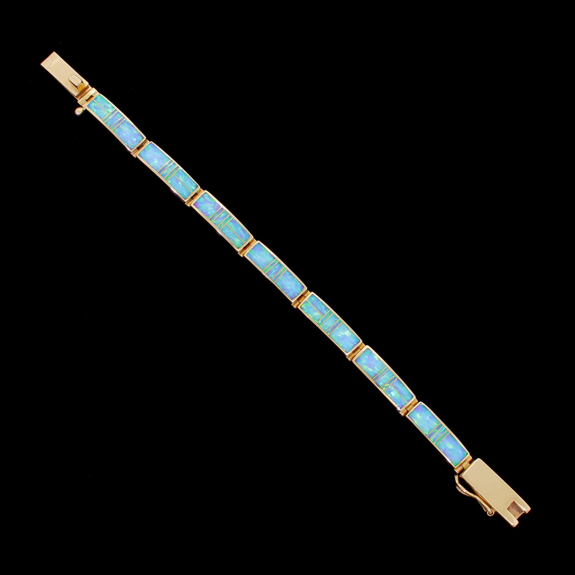 Beautiful 14K yellow gold & opal inlay bracelet by Native American artist Tim Charlie for SuperSmith. This artisanal Navajo bracelet is quite substantial at 27.1 grams. It is of high quality, and very well made. All the opal sections have a