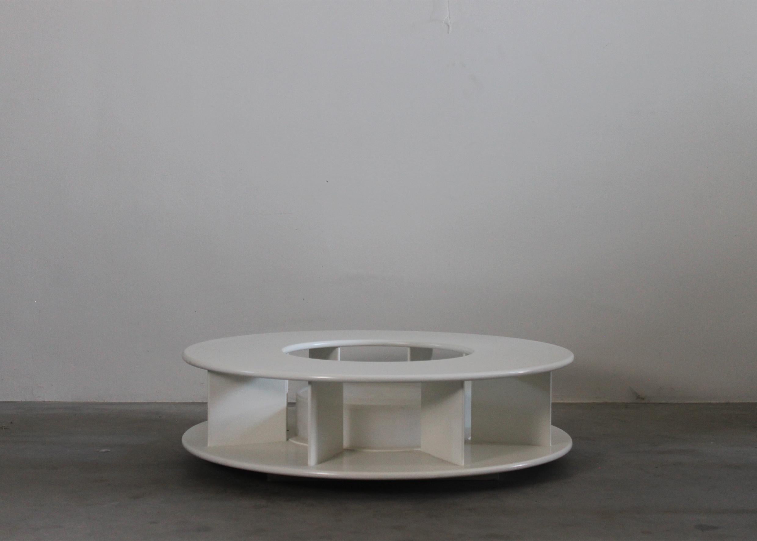 A low round-shaped coffee table model Bazaar with structure in white lacquered wood and ABS, the table presents an inner light implant. 
Designed by Superstudio and produced by Giovannetti in 1968, Italy.

Literature: AA. VV. Dal cucchiaio alla