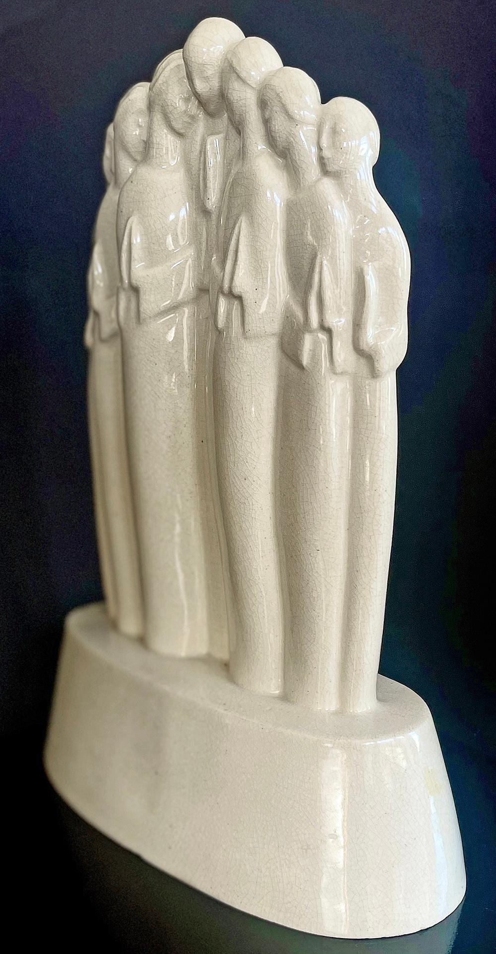 One of the rarest and most important sculptures eminating from the ARKO ceramic school established by Alexander Archipenko in Woodstock, New York, this stylized group of praying figures was created by Lu Duble. Archipenko studied in Kiev and Paris