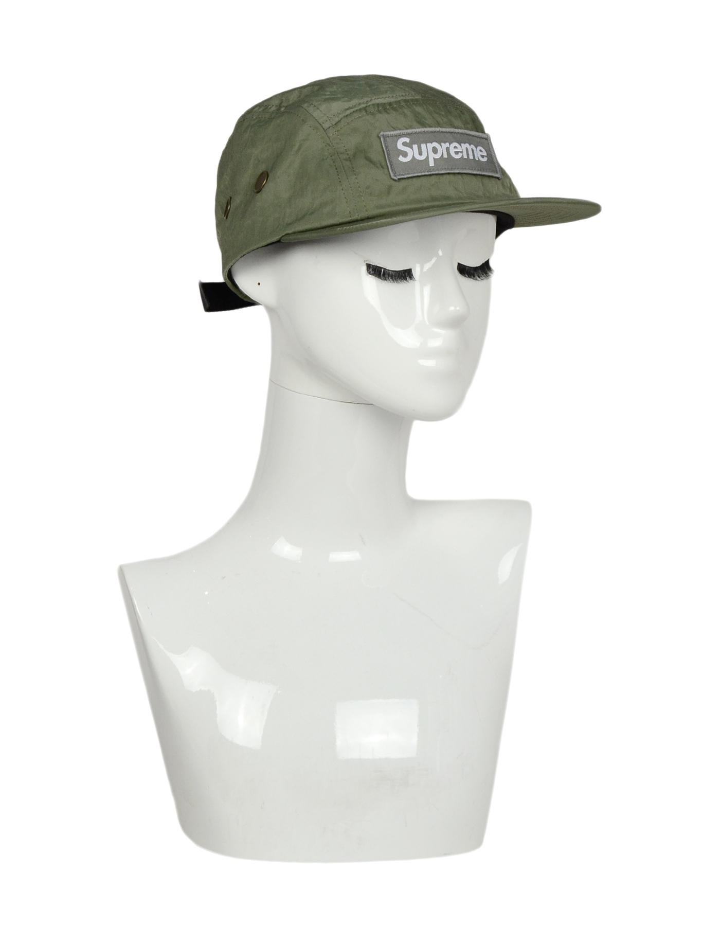 Supreme Green Logo Camp Hat

Made In: USA
Color: Olive green 
Materials: Nylon
Opening/Closure: Pull on with adjustable strap
Overall Condition: Excellent pre-owned condition
Measurements 
7.5
