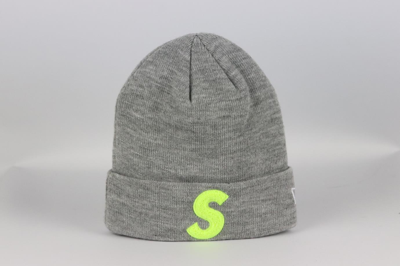 Supreme + New Era embroidered knitted beanie. Grey. Slips on. 100% Acrylic. Does not come with dustbag or box. Size: One Size: Length: 8.5 in. Circumference: 17 in. Very good condition - As new condition, no sign of wear; see pictures.