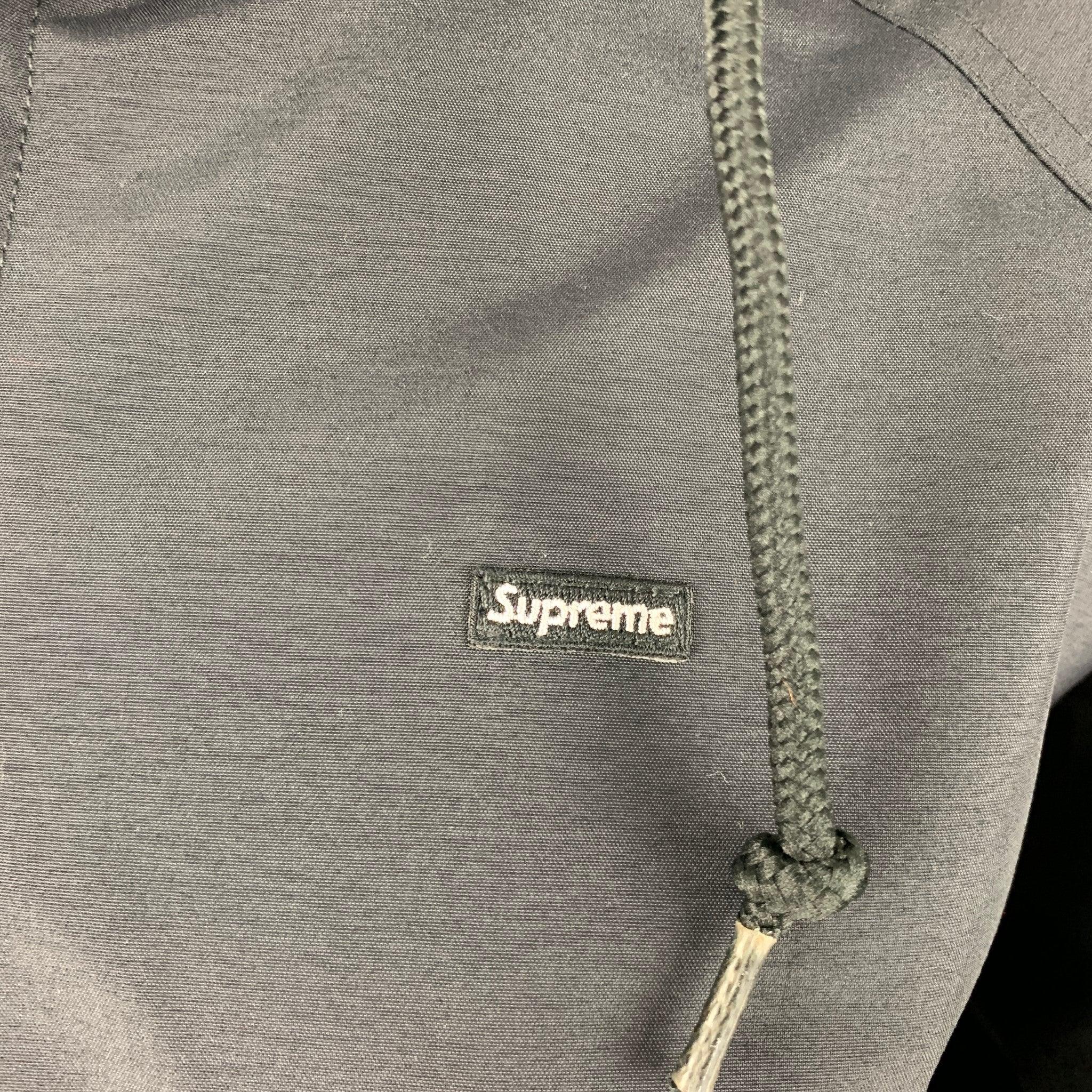 SUPREME jacket
in a
black nylon featuring waterproof GORE-TEX technology, a hooded windbreaker style, and zip up closure.New with Tags. 

Marked:   S 

Measurements: 
 
Shoulder: 17 inches Bust: 42 inches Sleeve: 25 inches Length: 24 inches 
  
  

