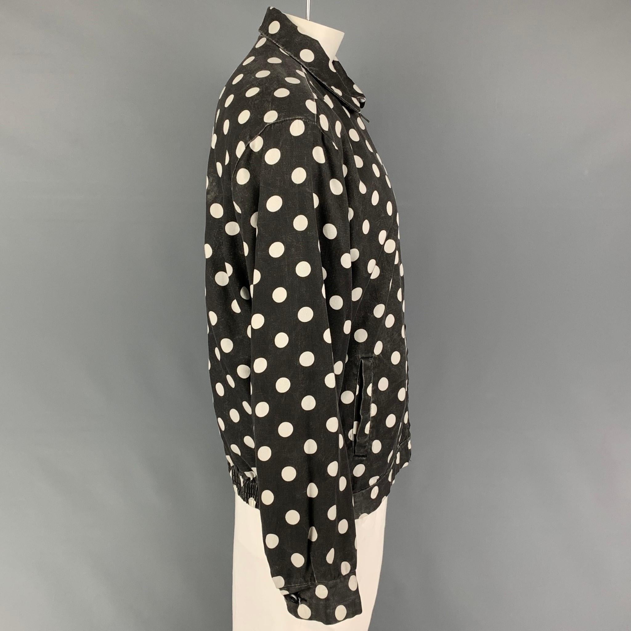 SUPREME jacket comes in a black & white polka dot rayon featuring a spread collar, back elastic trim, slit pockets, and a full zip up closure. 

Good Pre-Owned Condition. Light mark at front. As-Is.
Marked: XL

Measurements:

Shoulder: 21.5
