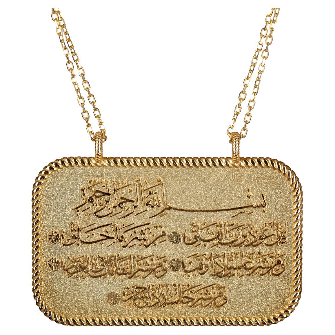 A charming 18K gold necklace with exquisite Arabic calligraphy engraving of Surah Al Falaq (The Daybreak), a chapter of the Qur'an that is read to offer protection and ward off evil. The Surat al Falaq necklace expresses a firm belief in the