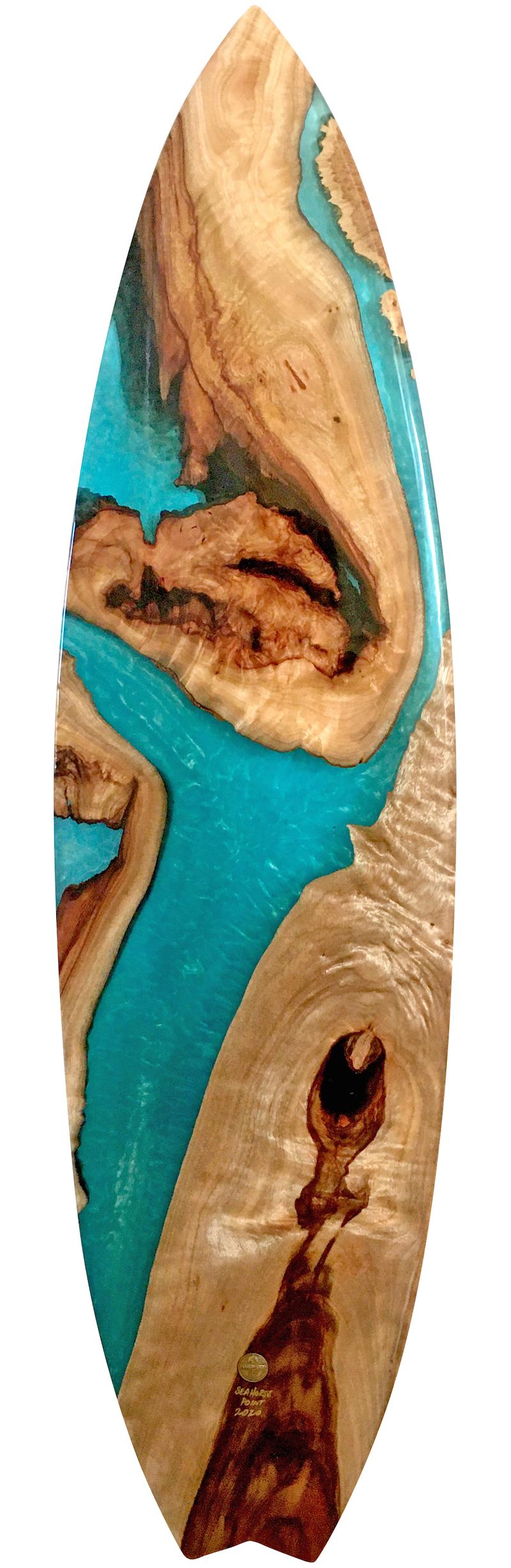 One of a kind “Seahorse Point” finless surfboard work of art by Australian artist Joshua Marks. Featuring a camphor laurel and maple natural edge wood composition fused with turquoise clear epoxy resin and blue/green pearl pigments.